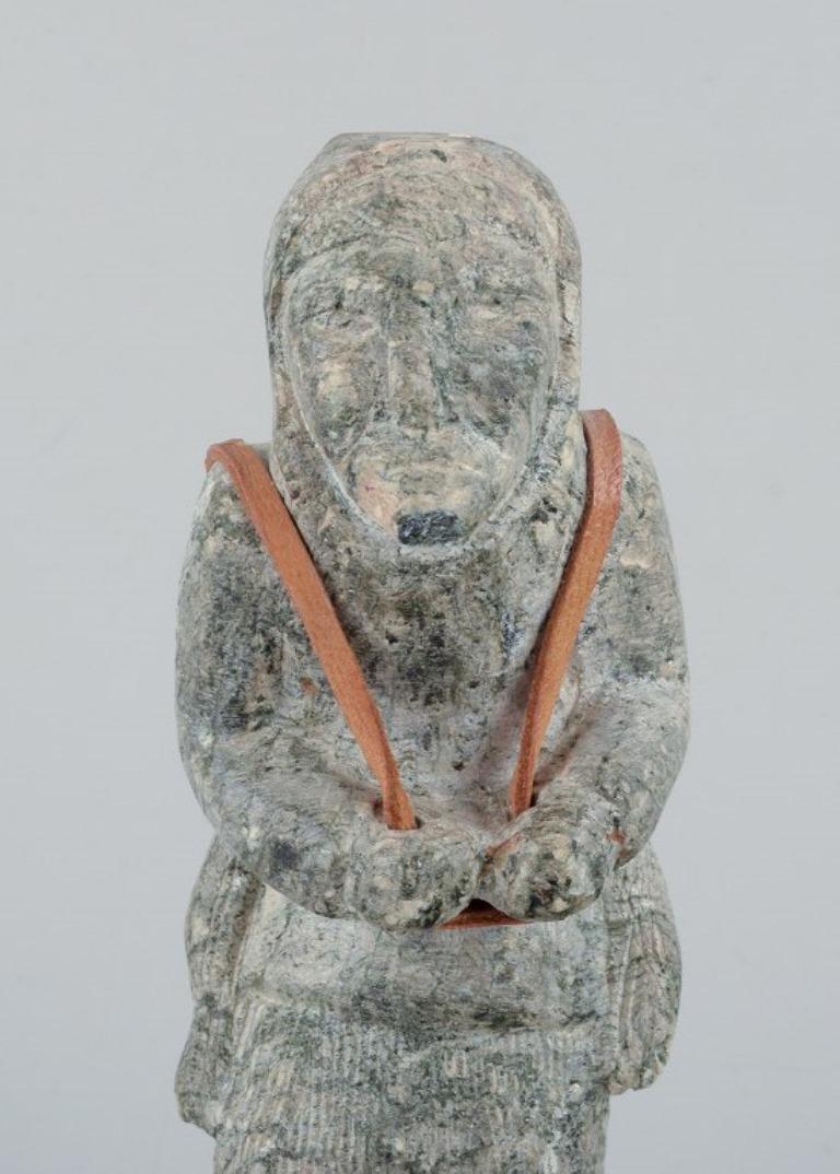 20th Century Greenlandica, old hunter with a seal on his back, sculpture in soapstone. For Sale