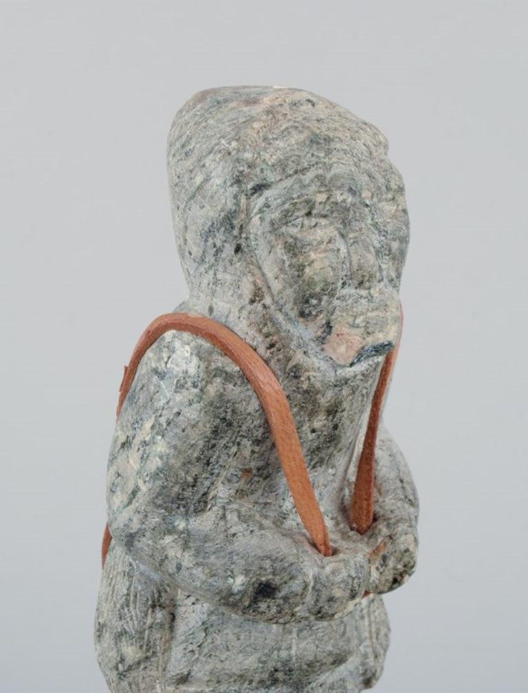 Soapstone Greenlandica, old hunter with a seal on his back, sculpture in soapstone. For Sale