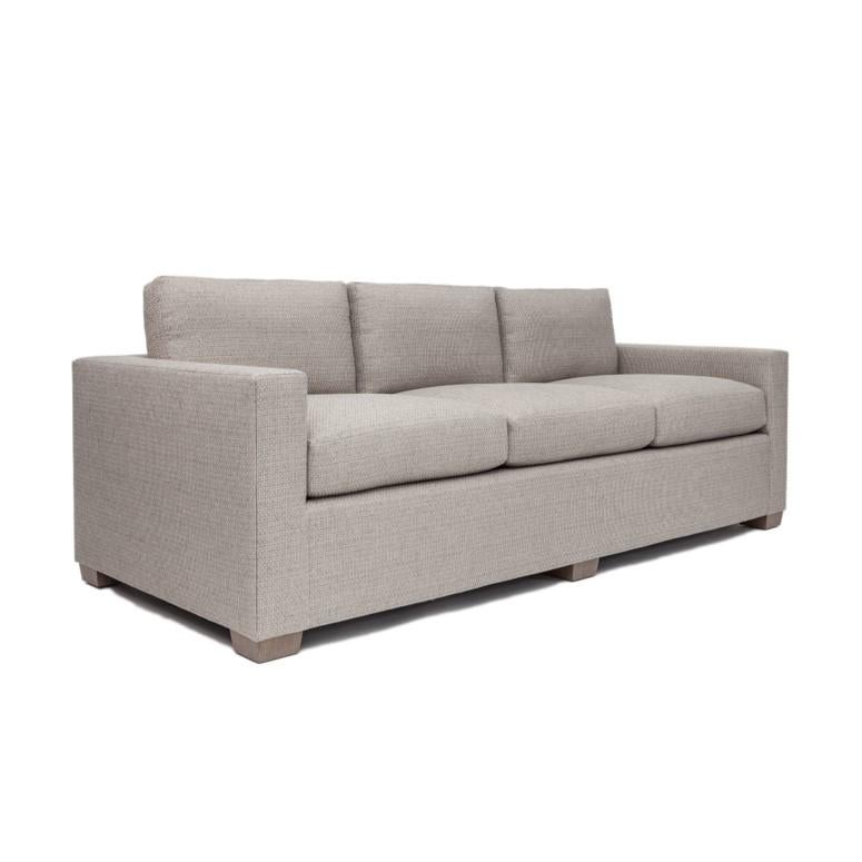 Classic, square arm sofa with three, loose seat and back cushions. The Greenwich Sofa frame is constructed using solid maple wood with 50 / 50 down feather filled cushions. Four finishes available for sofa legs. Available in four cotton fabric