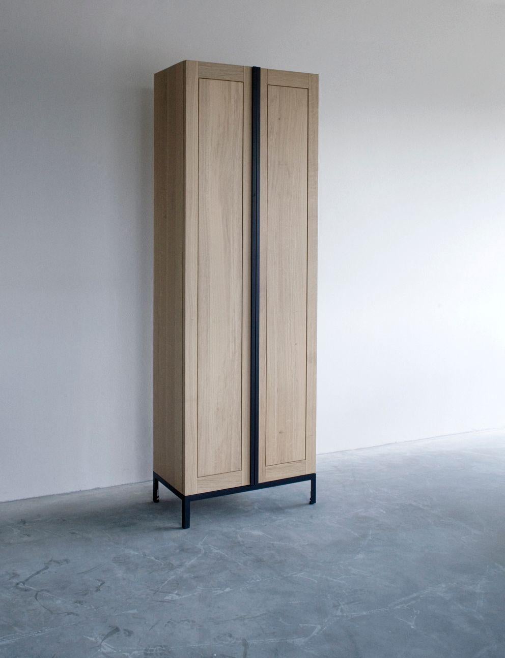 Greep cabinet by Van Rossum.
Dimensions: D76 x W41 x H226 cm
Materials: Oak, steel.

The wood is available in all standard Van Rossum colors, or in a matching finish to customer’s own sample.
The steel frames are protected by a powder coating
