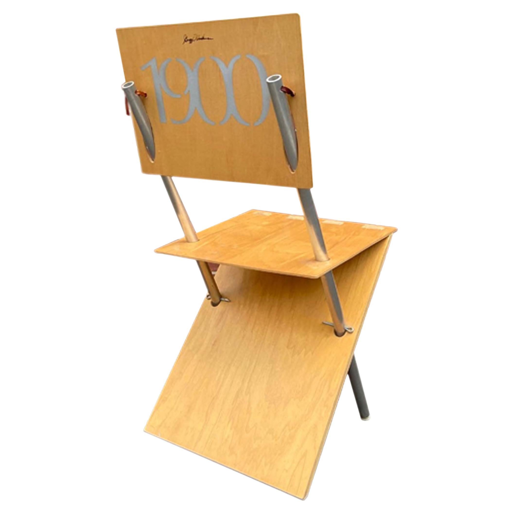 A 1990s Postmodern wood and metal chair designed by American architect Gregg Fleishman. The artistically designed chair is composed of three Euro Birch plywood panels that are pierced and supported by two metal rods, pins, and leather ties. The back