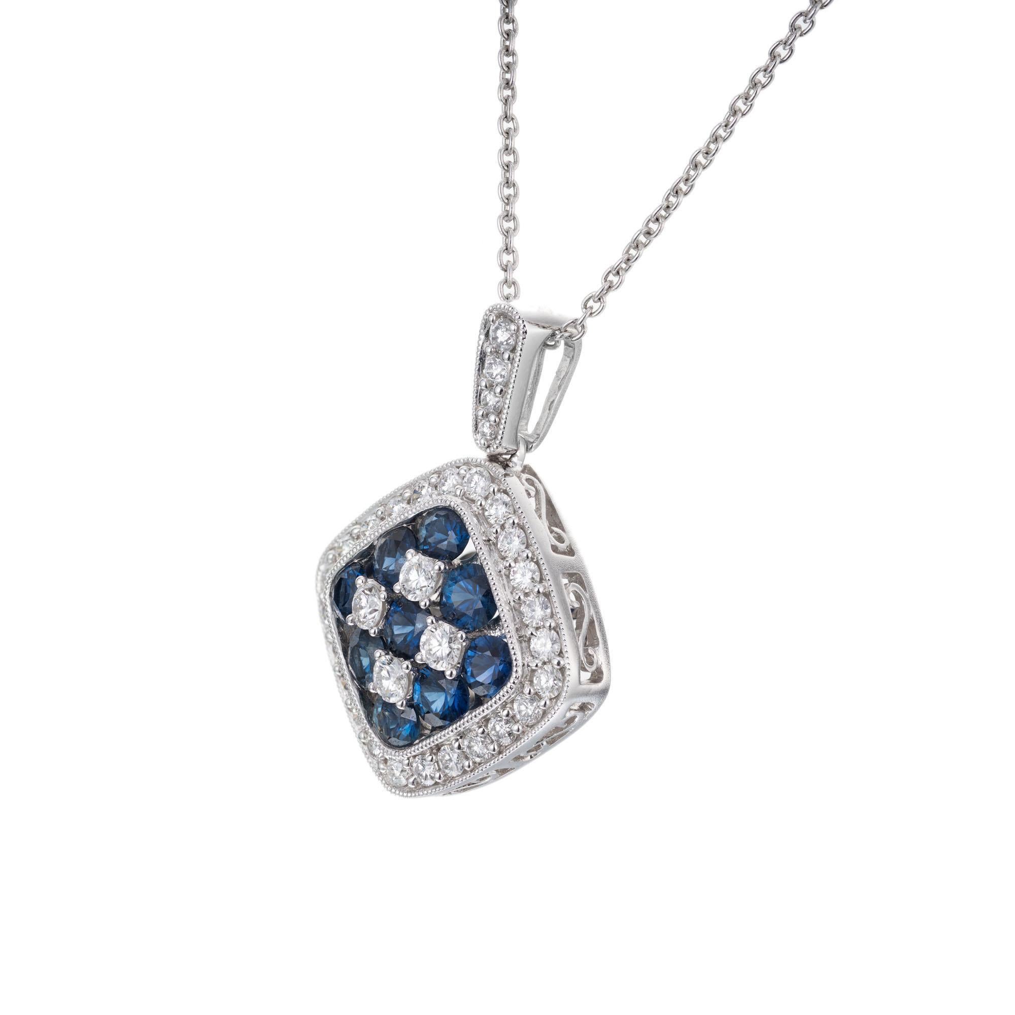 Gregg Ruth vivid blue sapphire and diamond Halo pendant necklace. 18k white gold cushion shape 

9 round bright blue sapphires, VS approx. 1.25cts
32 round brilliant cut diamonds, G VS approx. .64cts
18k white gold 
Stamped: K18
Hallmark: Gregg Ruth