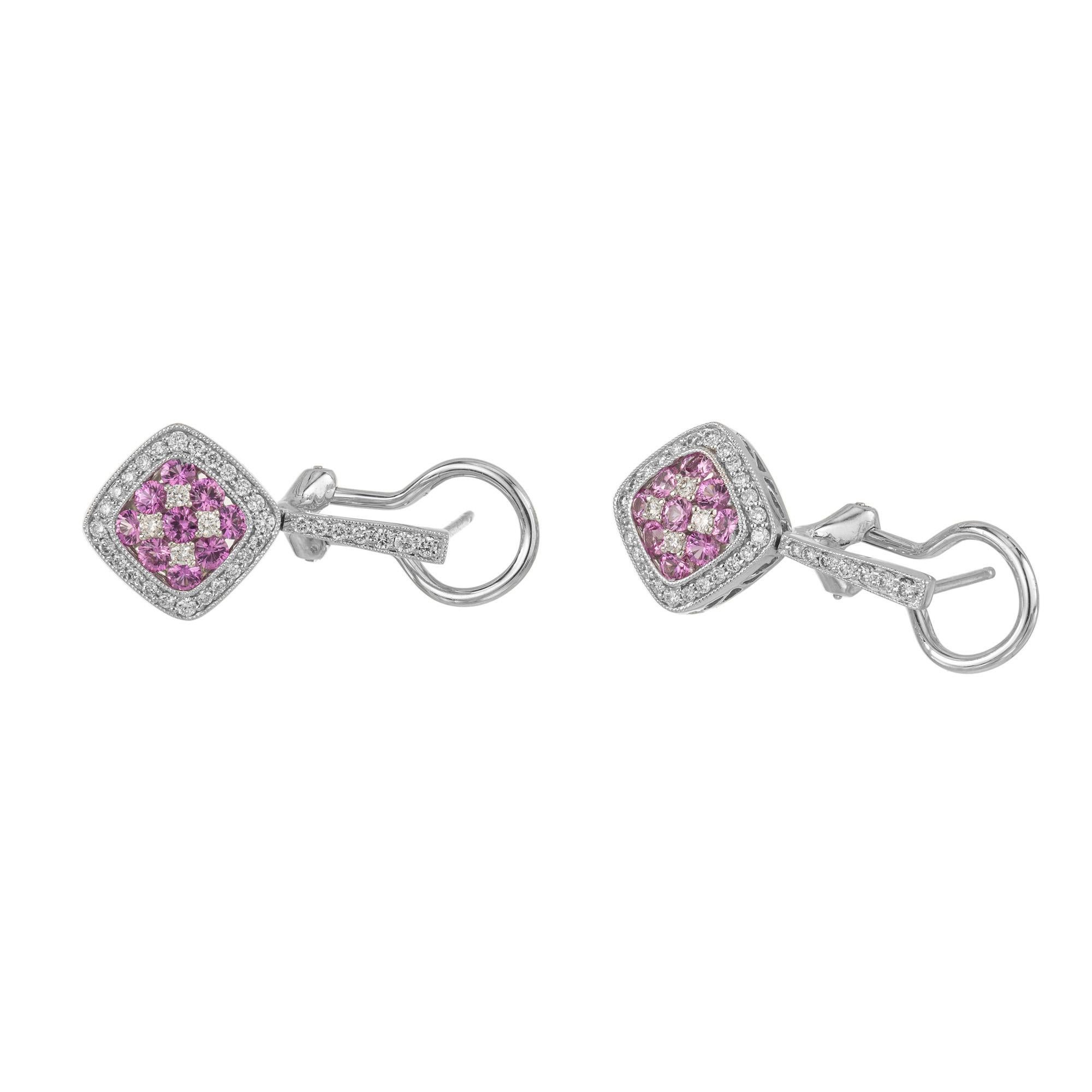 Gregg Ruth pink Sapphire and diamond dangle earrings. These wonderful earrings are 18k white gold with clip and post for maximum security. The centers are set with 4 round cut diamonds and 9 round pink sapphires. The clusters enhanced by round