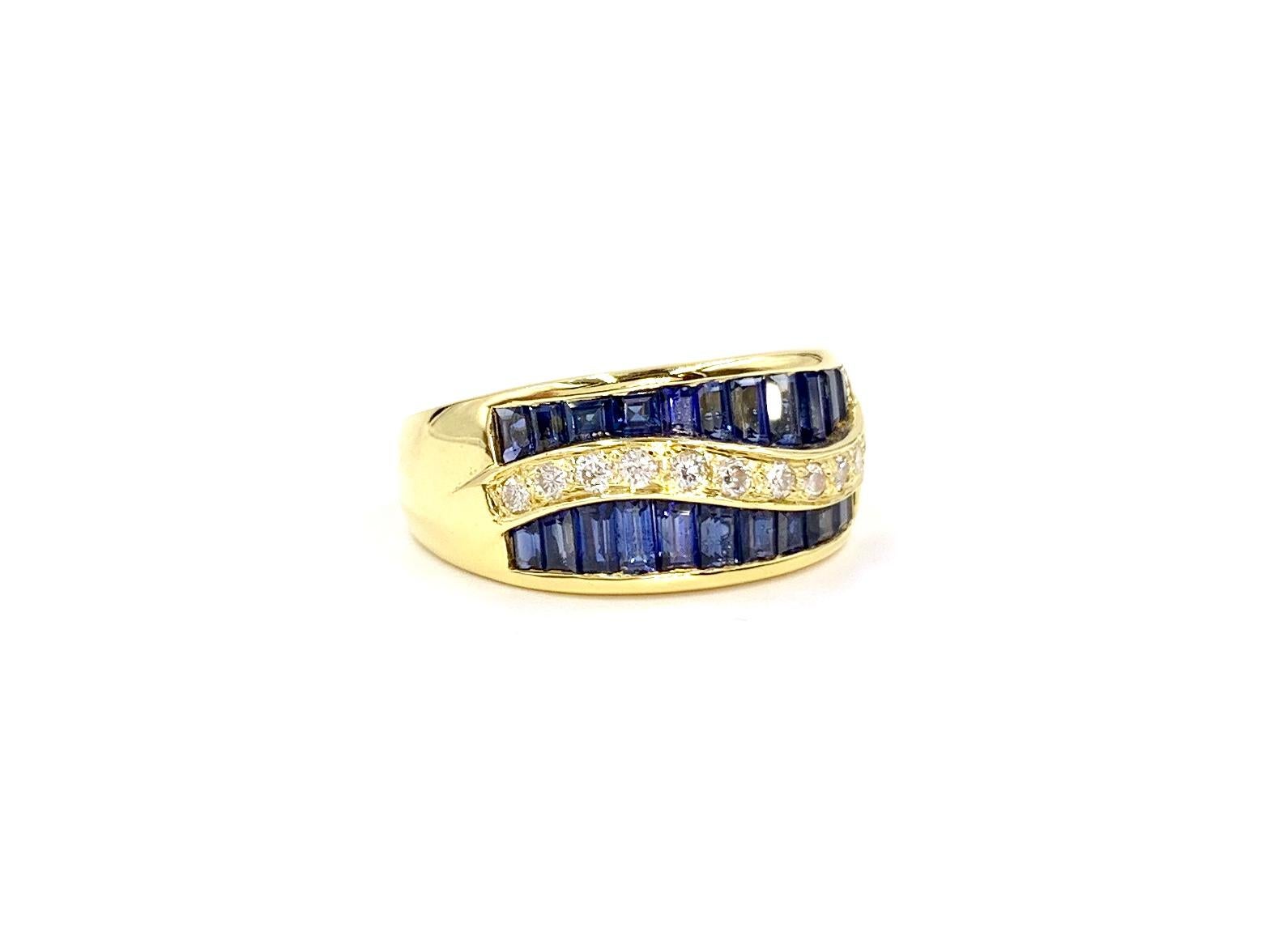 Crafted with extraordinary quality by designer Gregg Ruth. This 18 karat yellow gold 10mm wide modern ring features vivid, well saturated baguette cut blue sapphires at 2.37 carats total weight and a wavy line of round brilliant diamonds at .23