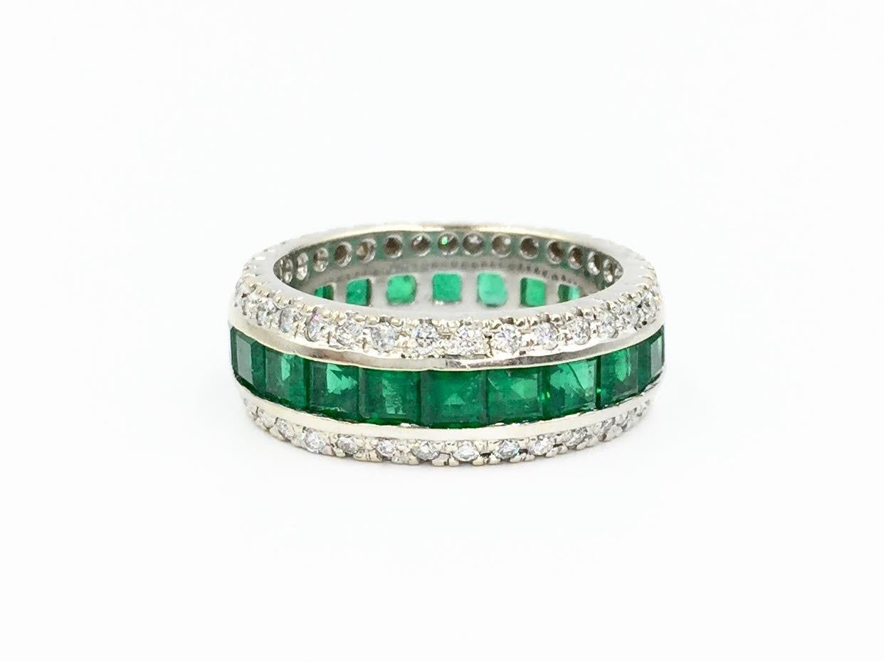 An 18 karat white gold emerald and diamond 7.5mm eternity band made with exceptional craftsmanship by Gregg Ruth. Approximately 4.50 carats of  high quality vivid and well saturated square emeralds are perfectly set in a center channel. Edges of