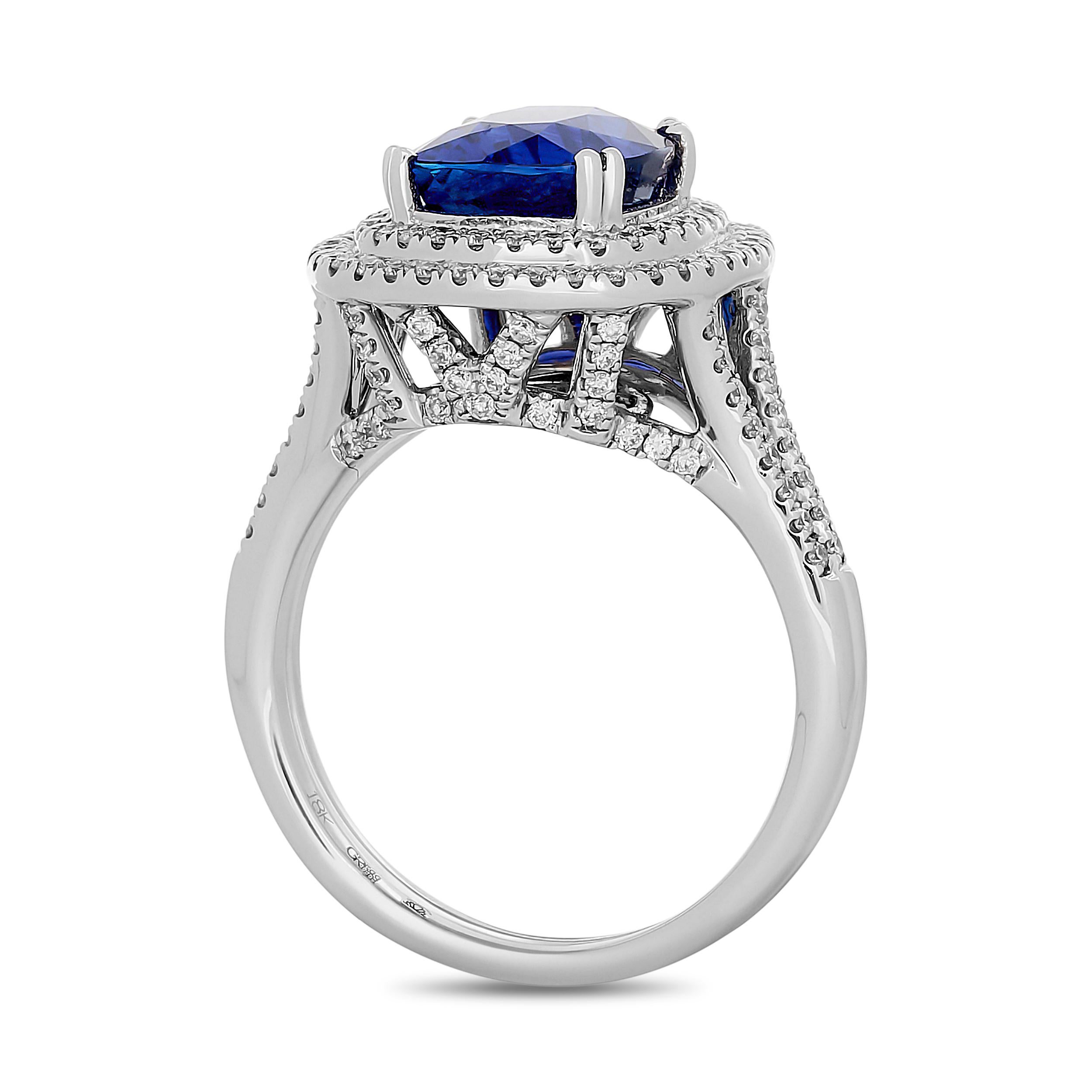 This Gregg Ruth ring features a stunning oval sapphire at its center, surrounded by a double halo of brilliant diamonds, with additional diamonds adorning the split shank.

 The center cushion shape sapphire weighs approximately 4.03 carats. The
