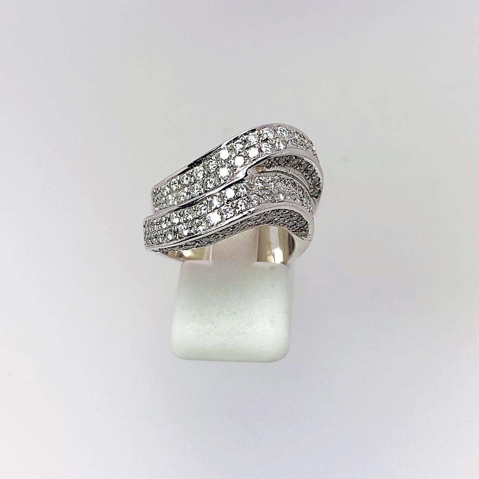 This 18 karat white gold double wave ring is pave set with round brilliant Diamonds. The beauty of this ring is that the Diamonds are set on the top and on all sides so that any way the hand turns you always see the Diamonds!!
Size 6.25  sizing