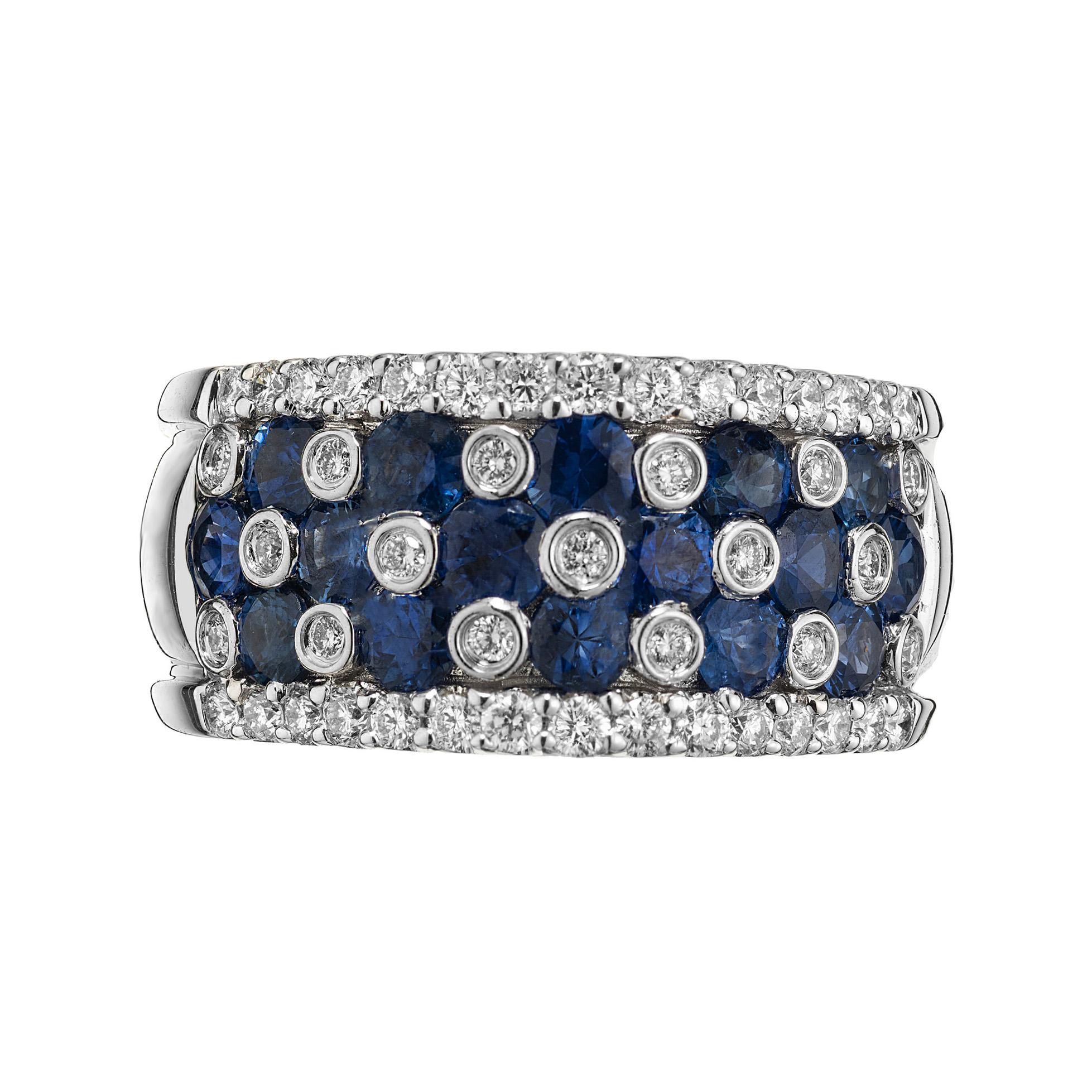 Discover the epitome of elegance with the Gregg Ruth Sapphire and Diamond white gold wide band ring, a masterpiece that captures the essence of luxury and style. This exquisite band is adorned with a triumphant array of 16 rich blue round sapphires,