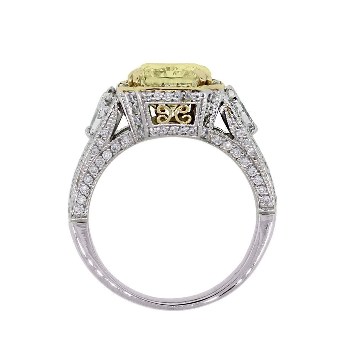 Designer: Gregg Ruth
Material: Platinum and 18k yellow gold
Center Diamond Details: Approximately 3.42ct radiant cut light fancy yellow diamond.
Diamond Details: Approximately 1.12ctw of trillion shape diamonds and round brilliant accent