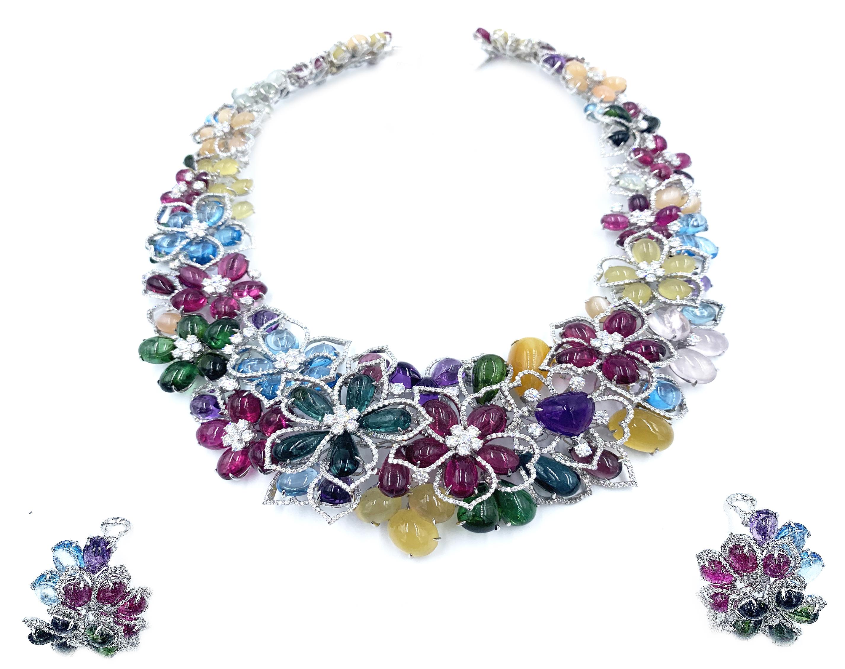 This beautifully hand crafted Multi-colored necklace, earrings, and ring suite from the renowned jeweler Gregg Ruth is from his ‘Malibu Beach Collection’. Made up of a fabulous array of colored stones, such as blue topaz, Amethyst, green and pink