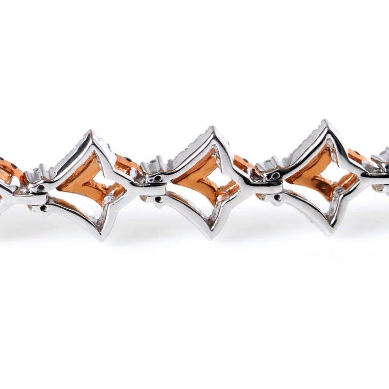 Exceptionally gorgeous Gregg Ruth bracelet in 18K white and rose gold and diamonds. The rose gold forms the smaller shape in this V-shaped bracelet set with pave pink and white diamonds. Total diamond weight - 6.03 ct.
Color and Clarity: GH /