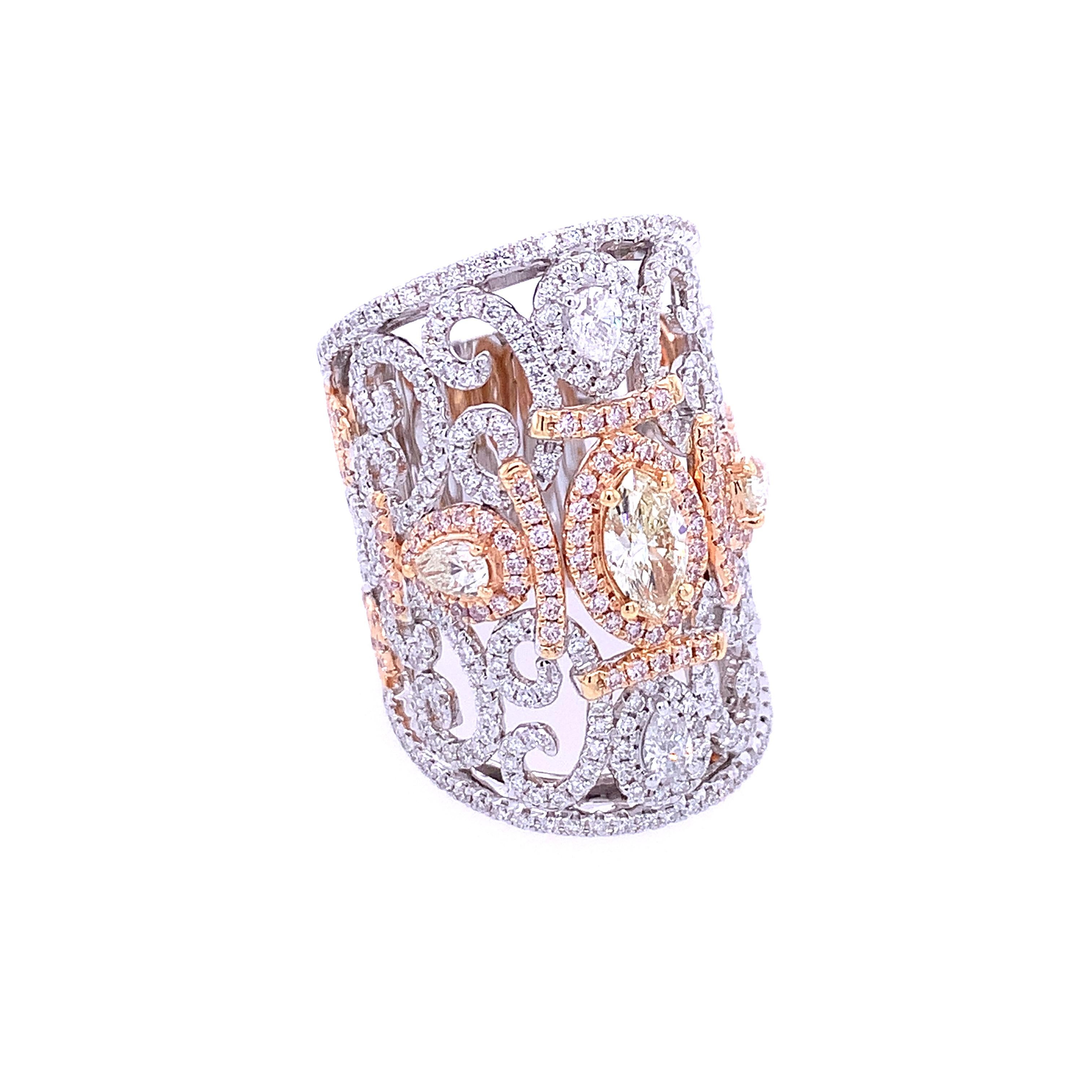 An enchanting 18K white, rose, and yellow gold contemporary ring intricately embellished with diamonds of pear shapes, marquise, and round cut. 2.12 carats of pave diamonds are nestled throughout filigree work. This classic ring highlights 0.91