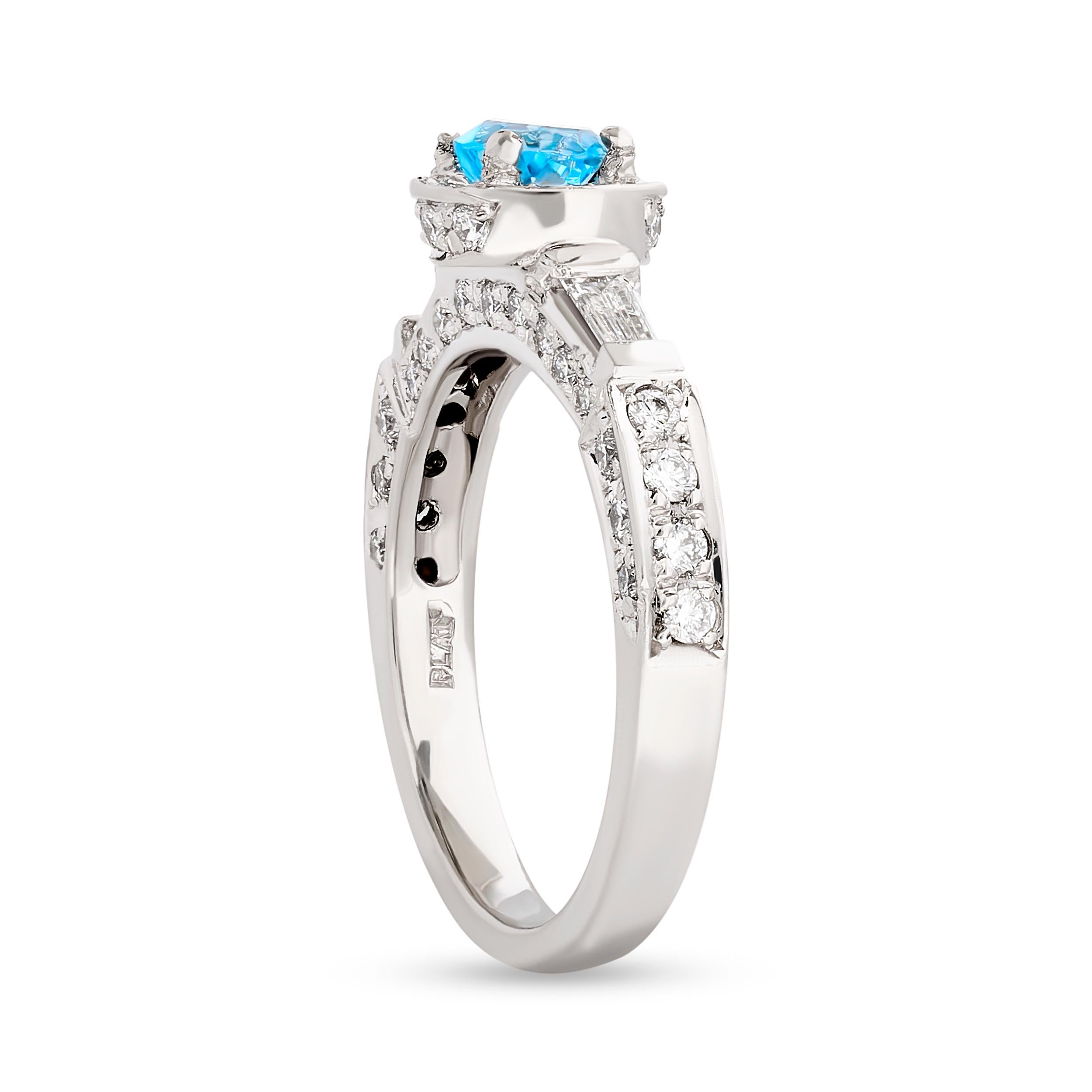 Make a statement with this stunning blue topaz and diamond halo ring from Gregg Ruth.
This Gregg Ruth ring has a bright blue topaz that weighs approximately 0.37 carat. It is surrounded by round diamonds in a halo, that weigh approximately 0.65