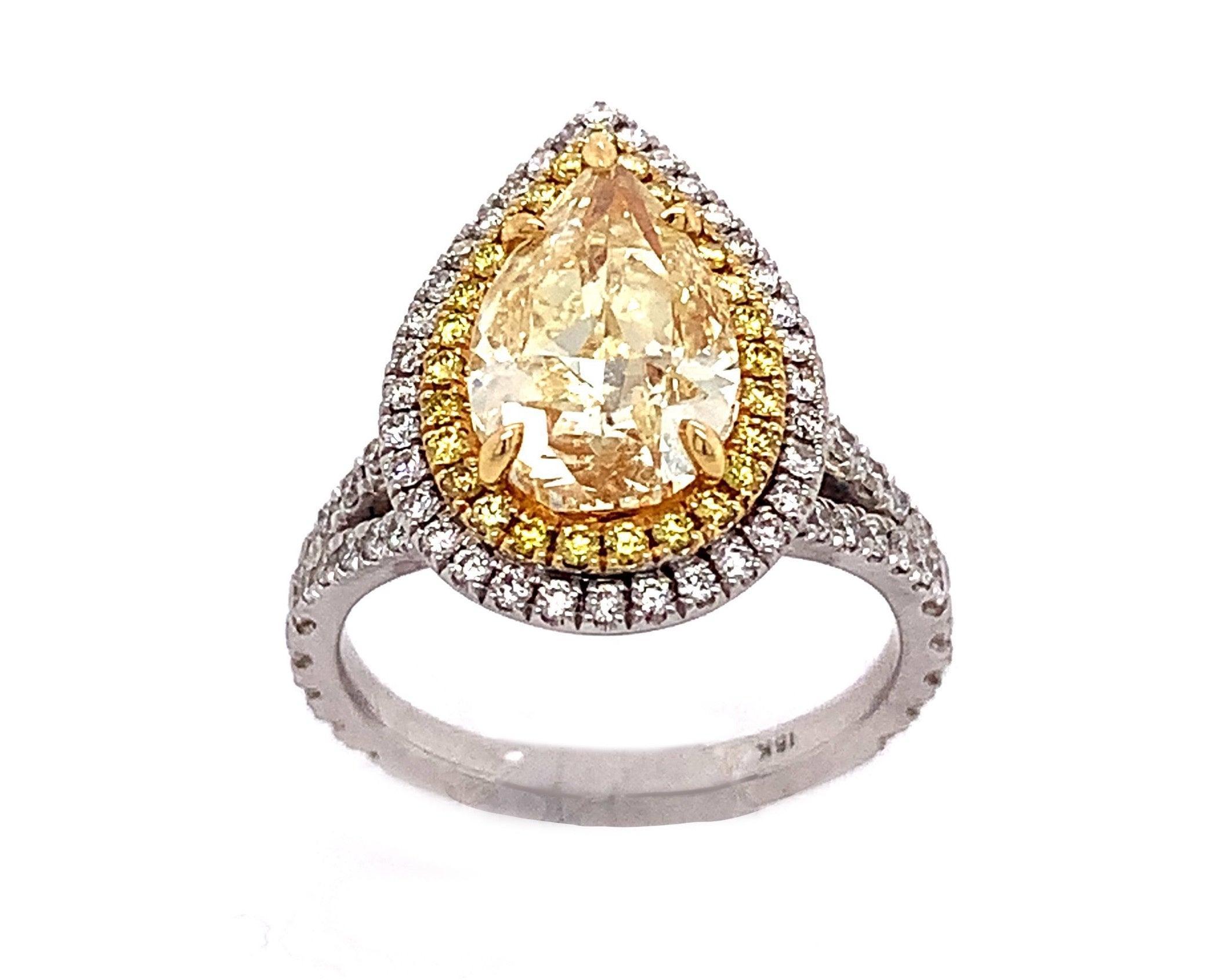 Gregg Ruth. 18-karat white gold setting with light yellow pear shape diamond center stone, 3.03ctw, Vs2 clarity. Double halo of white and yellow diamonds surrounding and half-way pave diamonds on the split shank band, 1.23ctw total. Size 6, can be