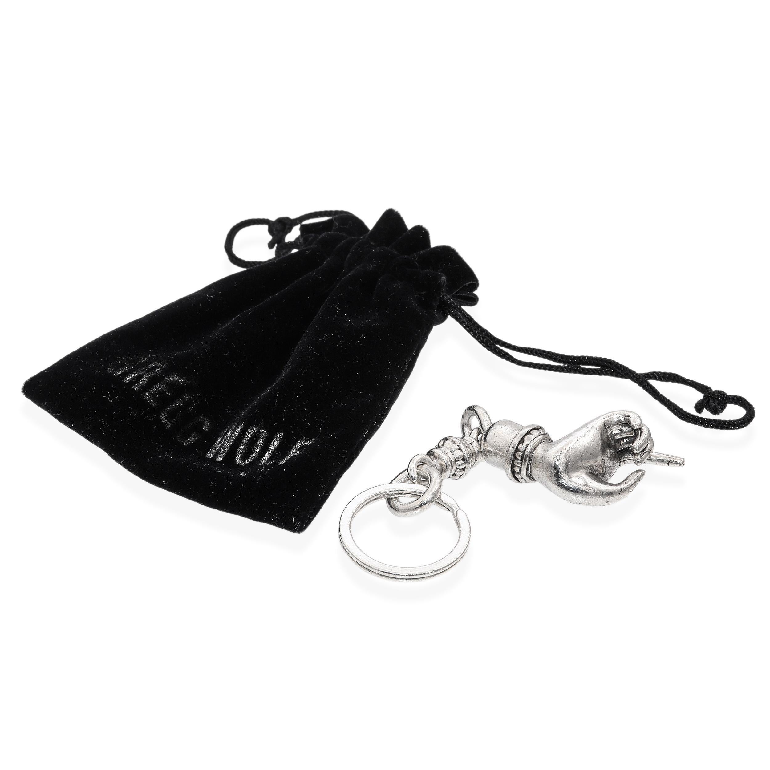 Unique and artistic Gregg Wolf sterling silver key ring featuring a detailed hand motif. The design showcases a sculptural hand with fine detailing, attached to a sturdy silver ring with decorative accents. Crafted with Wolf’s signature attention to