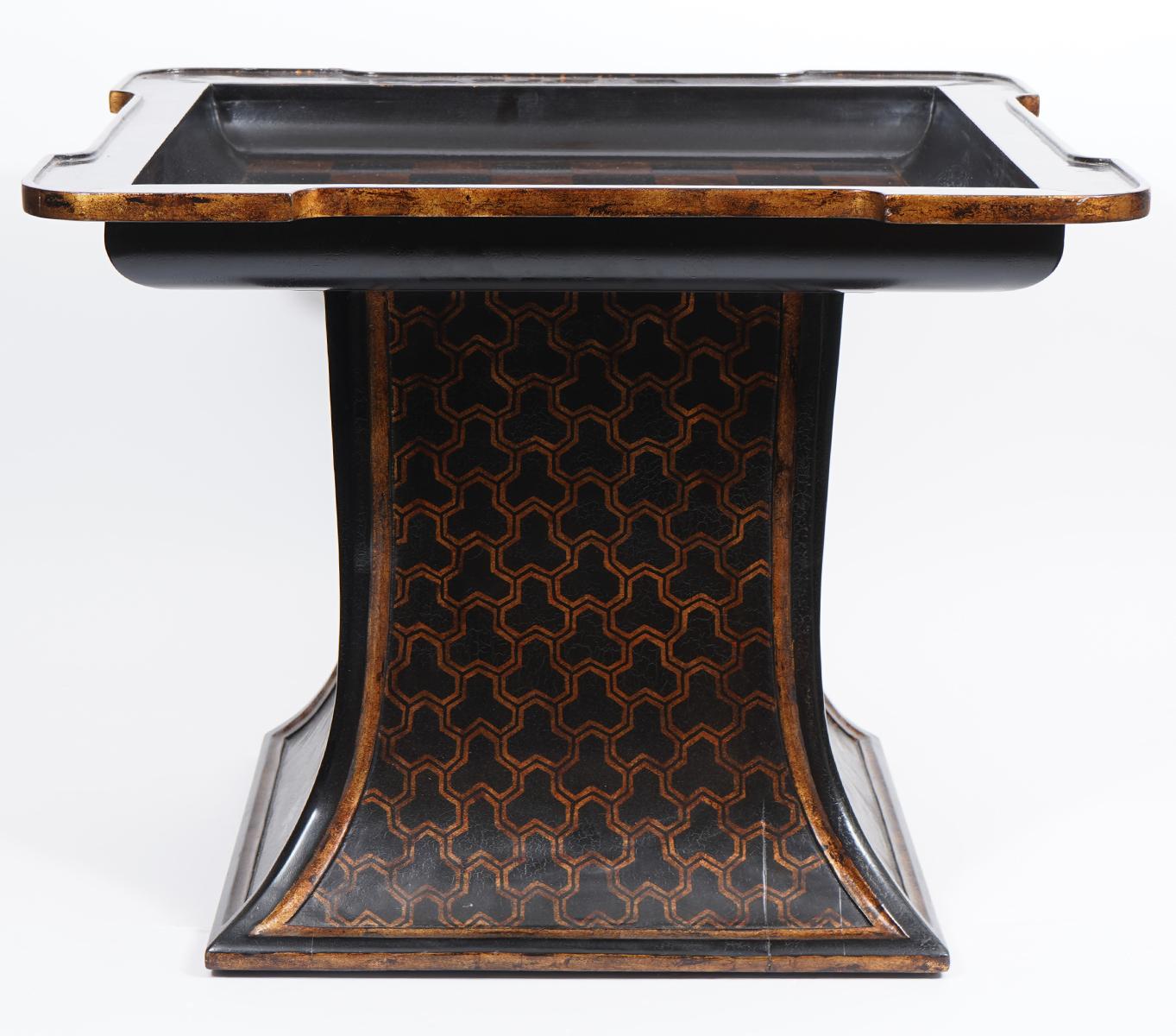 Ishizawa side table by Gregorius Pineo, Los Angeles. Has planked top with gilt detailed borders and raised edges, lacquered finish. Pedestal base has gilt Chinoiserie design. Checkerboard top with fitted glass top not shown but will be included.