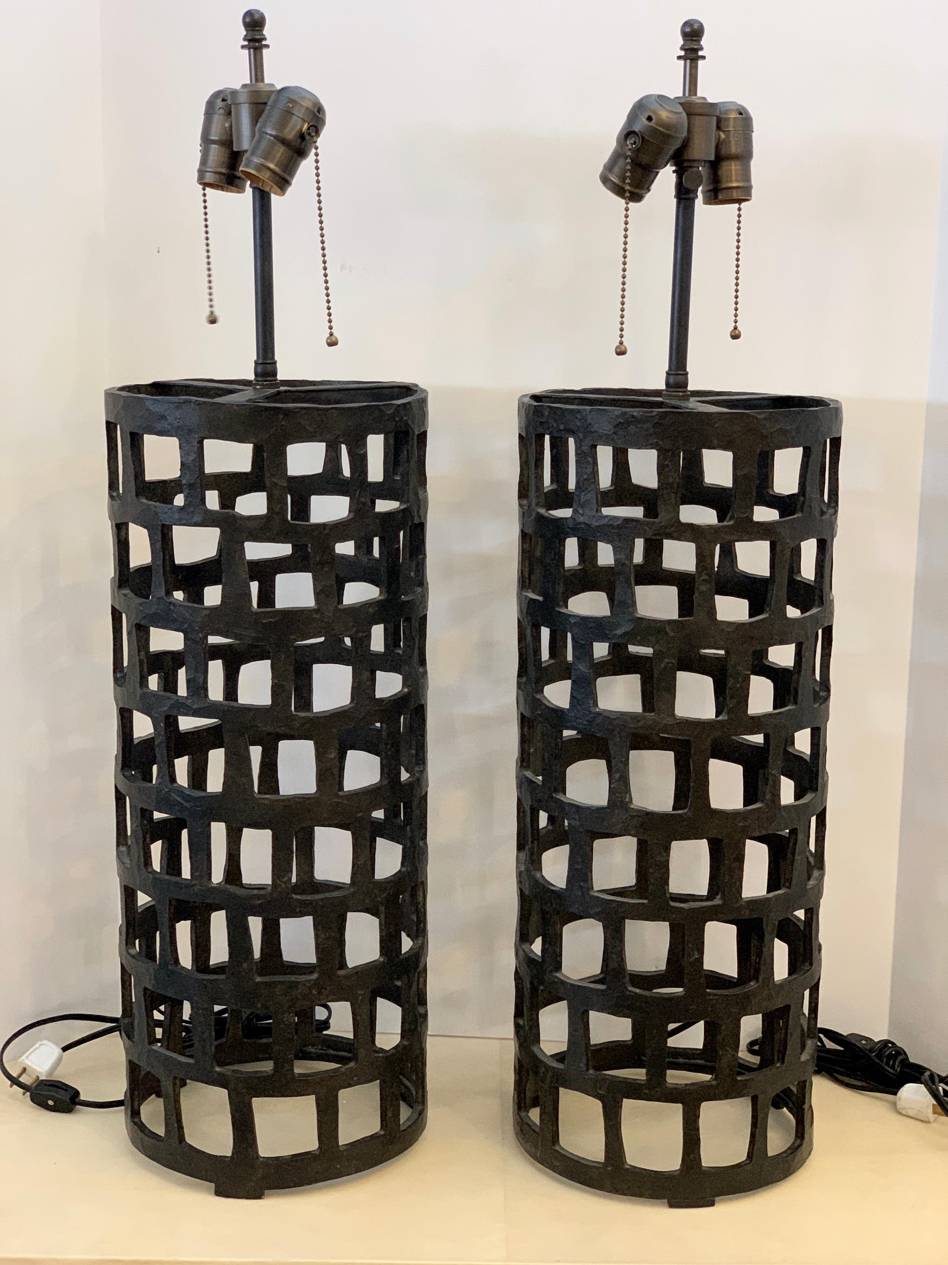 A nice pair of patinated Iron lamps by Gregorius Pineo. They are recent lamps and I believe they are part of the firm's Santorini Line. They are in good condition with minor marks from recent use. The original shades are available with purchase,