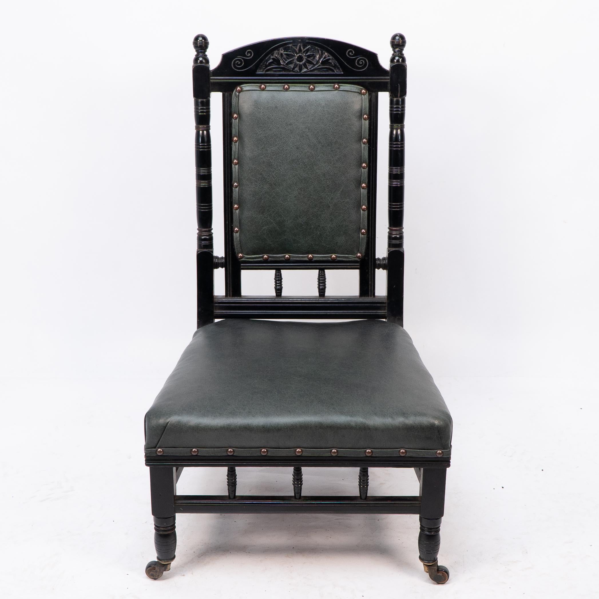 Gregory and Co. Regent St. London.

An aesthetic movement nursing chair with a stylized sunflower carving to the top, cup handle to the back flanked by turned finials with turned uprights to the sides on turned front legs united by a lower turned