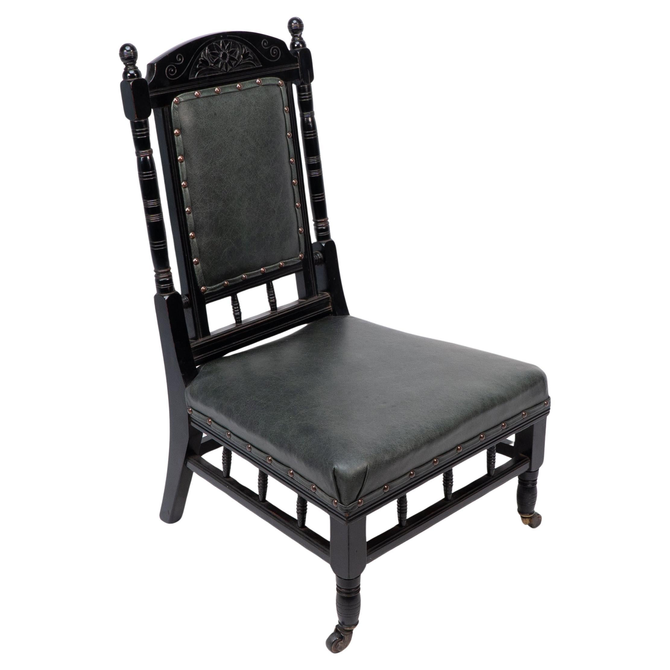 Gregory & Co. An Aesthetic Movement nursing chair with stylized carved sunflower For Sale