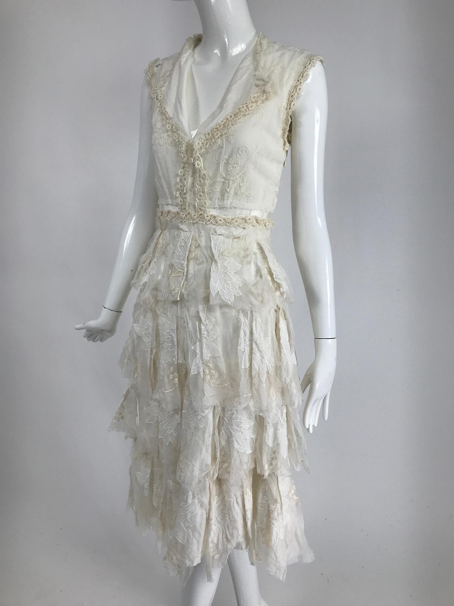 Gregory Parkinson pieced and appliqued white lace distressed style dress. Cute summer dress, pull on style with Collar and V neckline, the bodice is fitted, the dress closes at the side with a zipper.  A line satin dress is appliqued with bits of