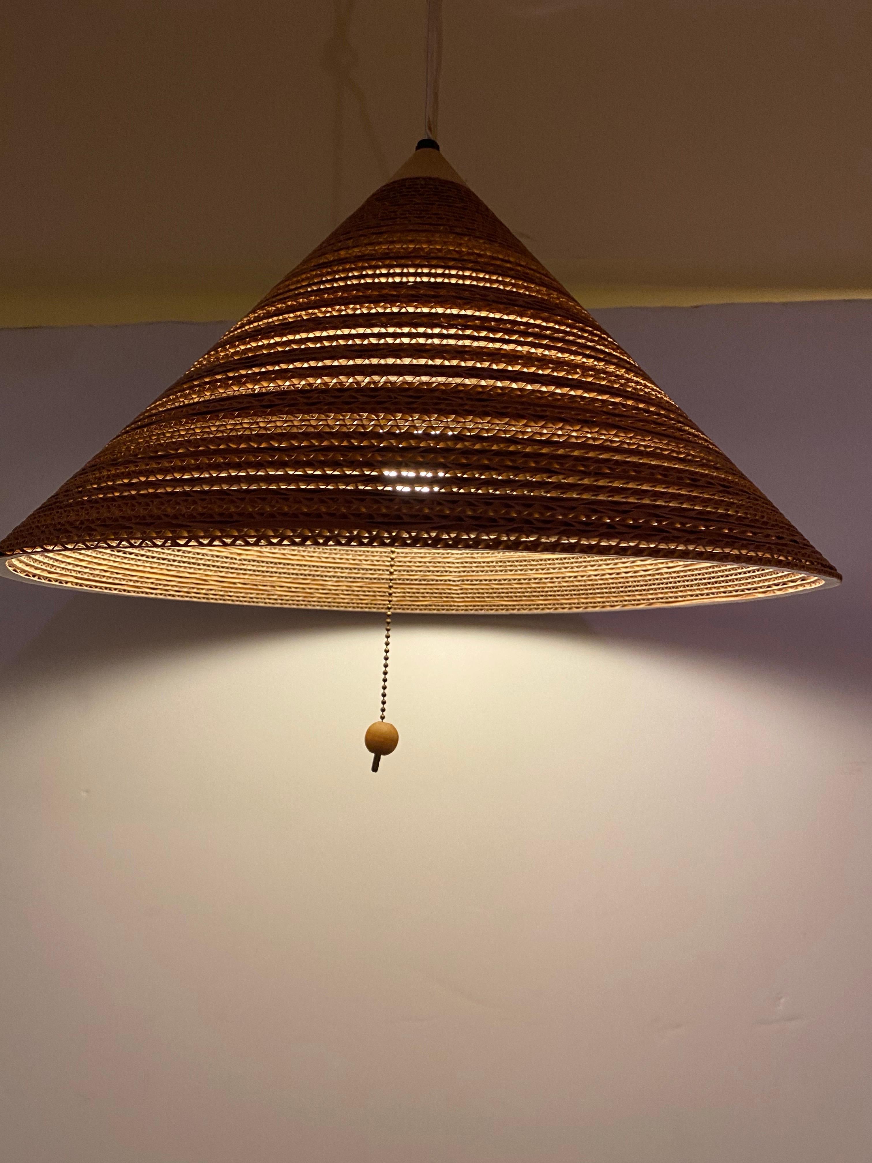 Gregory Van Pelt Stacked Cardboard hanging Fixture.  Wood cone top and hanging wood ball switch.  In nice original condition, iconic 1970's sensibilities and vibe.  Looks amazing when lit!  Perfect accent over your table.  Currently set up as a plug
