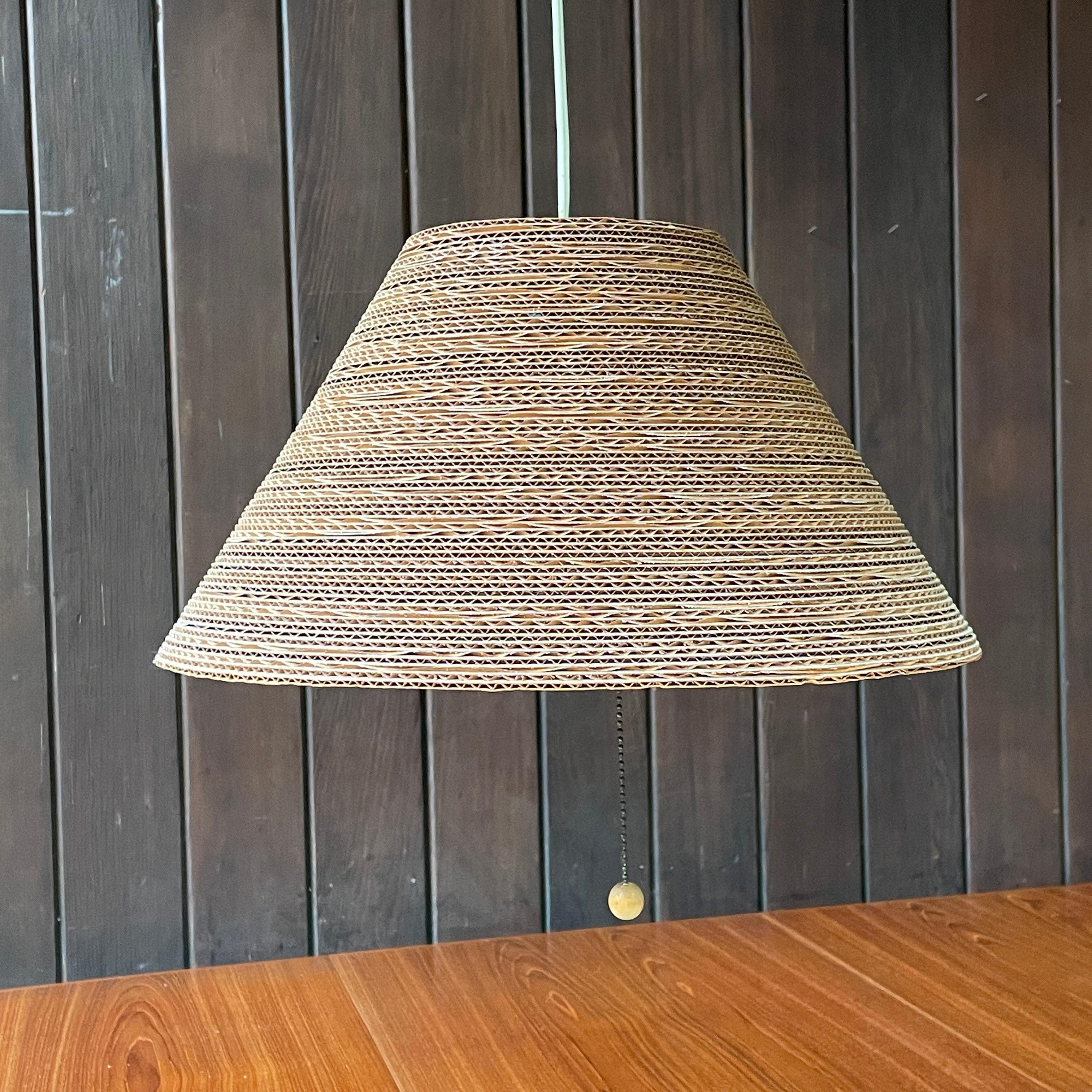 Wonderful stacked cardboard pendant lamp, harder to find these days.  Super fun piece from the Post-Modern or 'alternative materials' movement of the 1970s and 1980s and I guess crescendoed with Droog in the 1990s. Has the original wooden ball on
