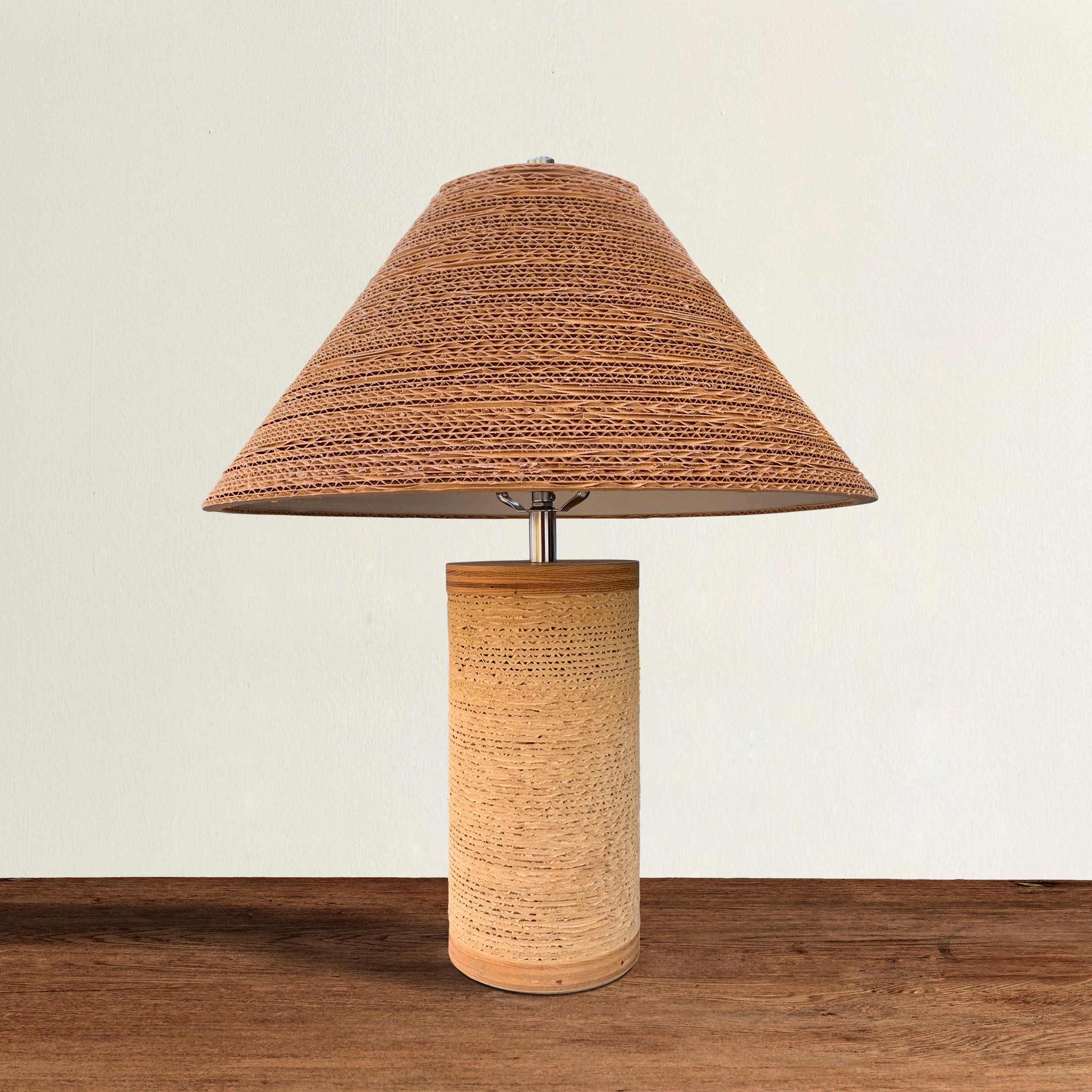 A playful but chic 1970s Gregory Van Pelt designed corrugated cardboard table lamp with a flared cardboard shade, and a cylinder body with laminated maple wood ends. Wired for US.