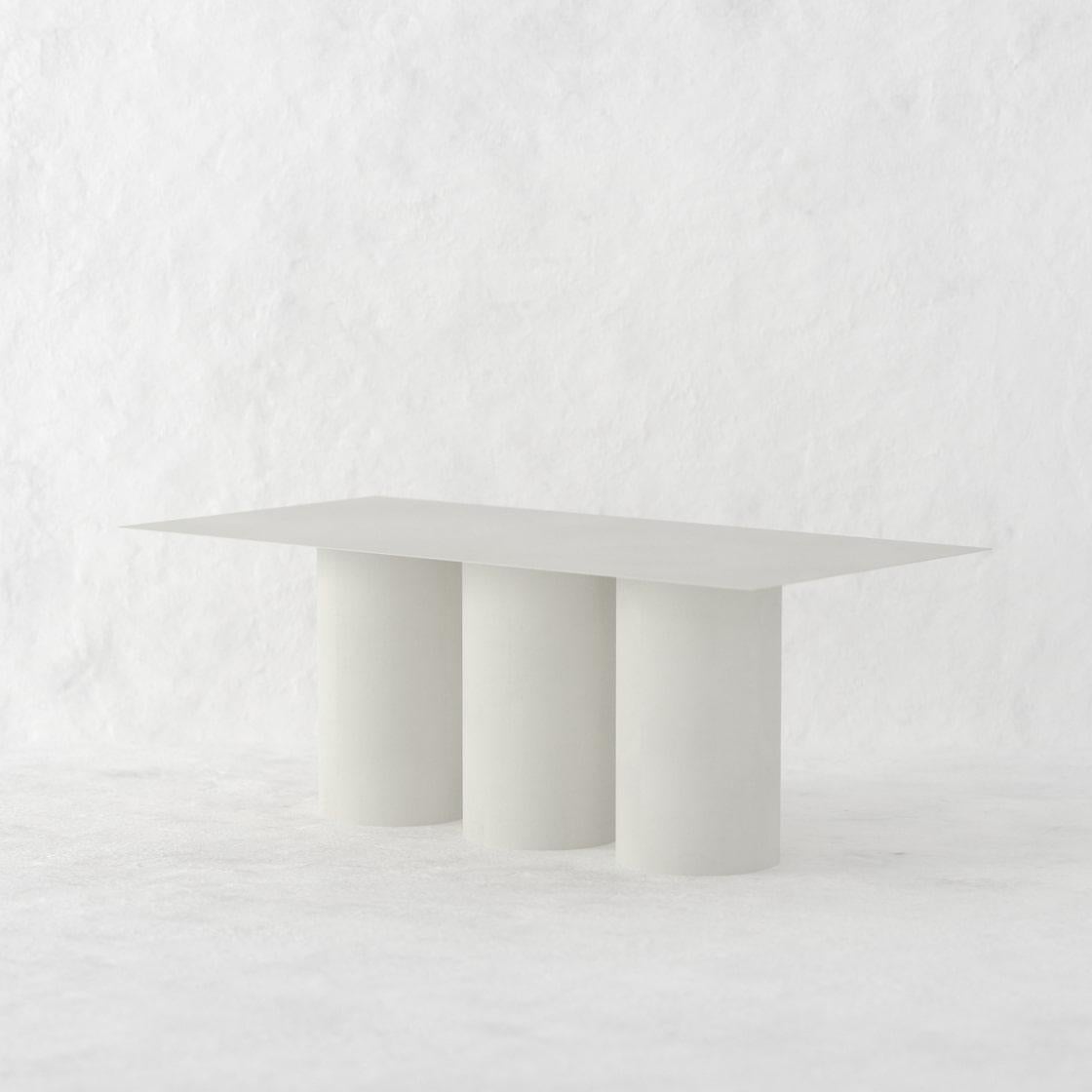 The Tripod Dining Table is a monolithic piece conceptualized as a dining table suitable for both, indoor and outdoor. 
Crafted by hand in metal and coated with a matte electrostatic finish it's size can be customized.
The Tripod Dining Table seats 8