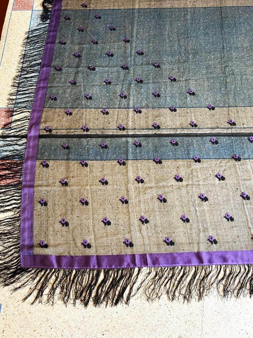 Circa 1860
France

Beautiful square Grenadine silk shawl, probably made in Lyon or Saint-Etienne around 1860. Transparent black silk with double twists (which defines grenadine silk). Decorated with purple fluted borders and a flower pattern on one