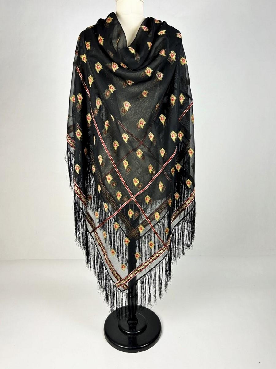 Circa 1860
France

Grenadine silk square shawl with remarkable transparency, probably made in Lyon or Saint-Etienne during the Second French Empire. Black silk woven with double twists (which defines grenadine silk). Decorated with a series of