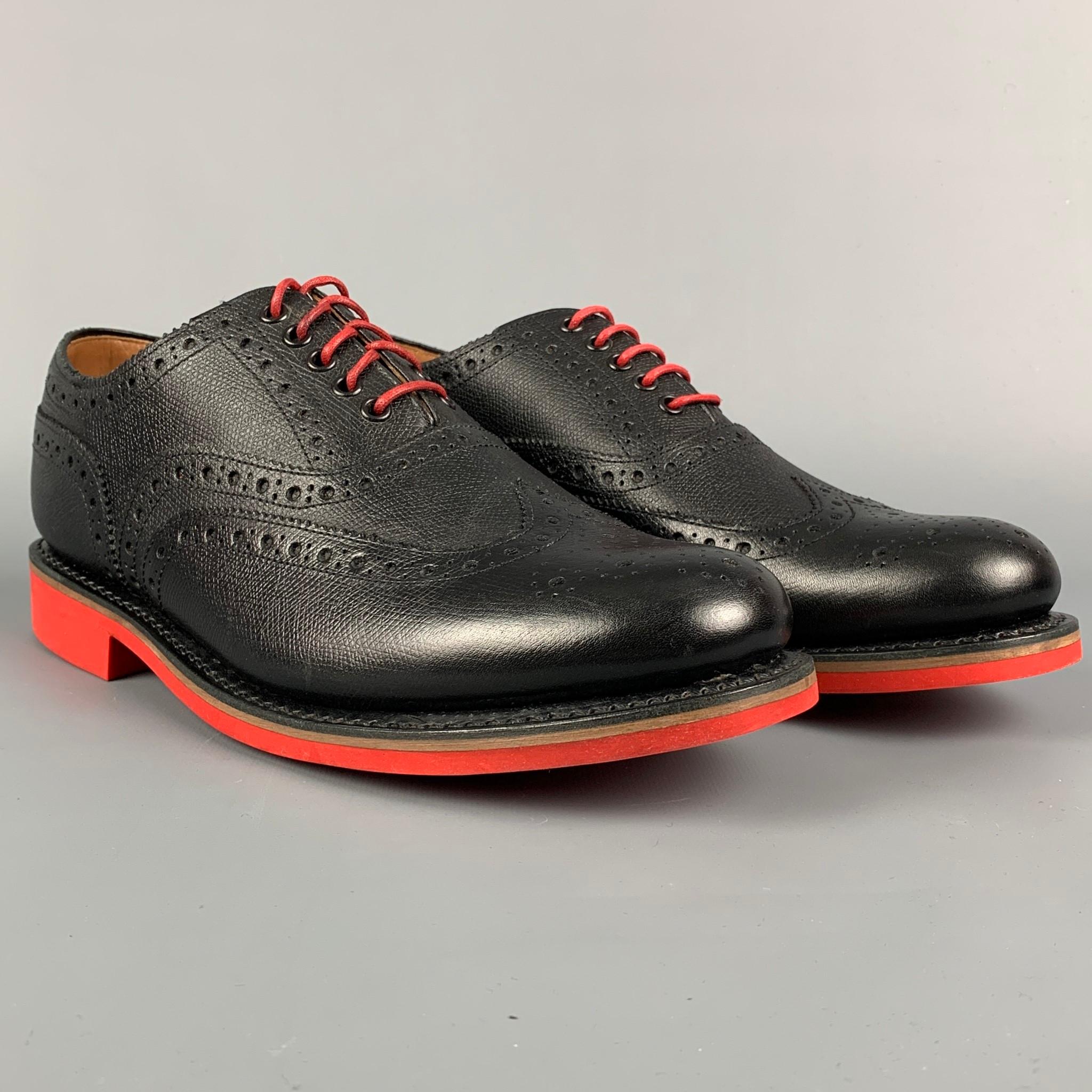 GRENSON shoes comes in a black perforated leather featuring a wingtip style, red rubber sole, and a lace up closure. Includes box. 

Excellent Pre-Owned Condition.
Marked: 5033 450RD 8.5 G

Outsole: 11.5 in. x 4 in. 