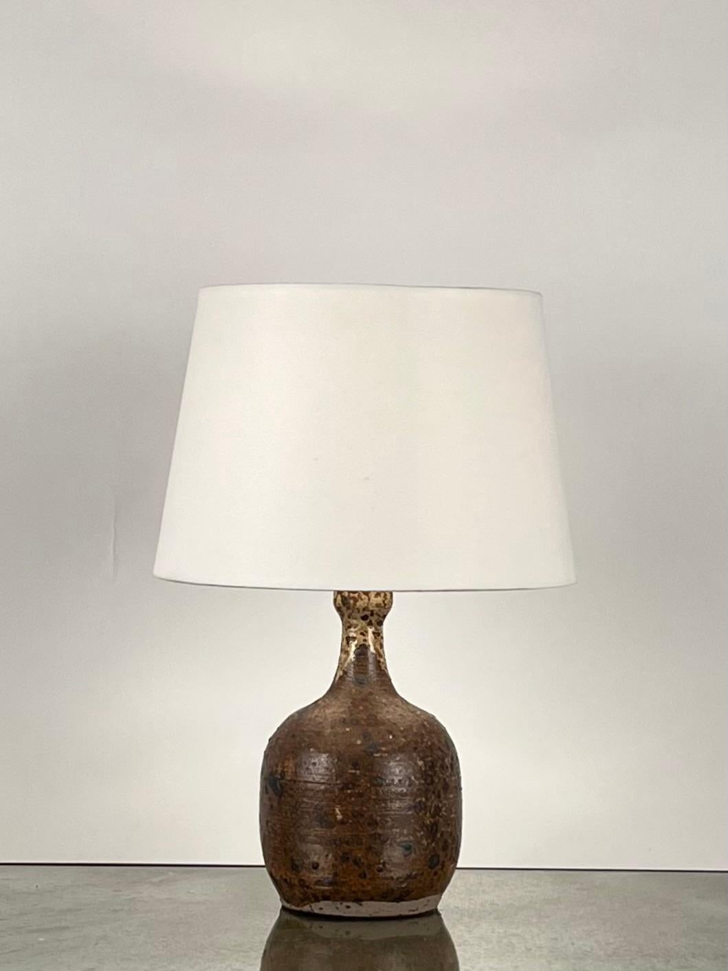 Grès Pyrité Stoneware Glazed Lamp by La Borne Pottery in France. 

Rewired with high-end twist cord and 3-way switch (on, half intensity, off). A 40w filament bulb is included in your order. 

Includes European style parchment shade (no harp or