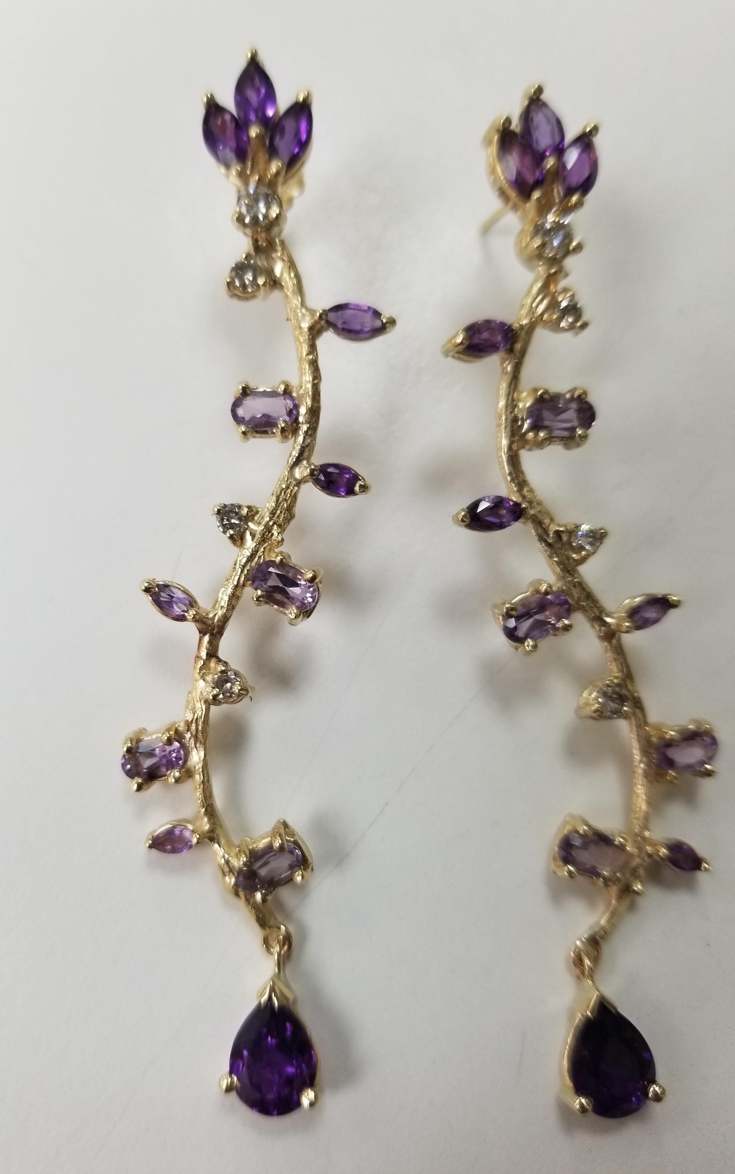 14k yellow gold Gresha signature bark and leaf with diamonds .55pts. and amethyst weighing 5.55cts.  There is a right and left ear, these are a beautiful dangle earring measuring 3 inches and weighing 11.90grams.

*this design is ours and can be