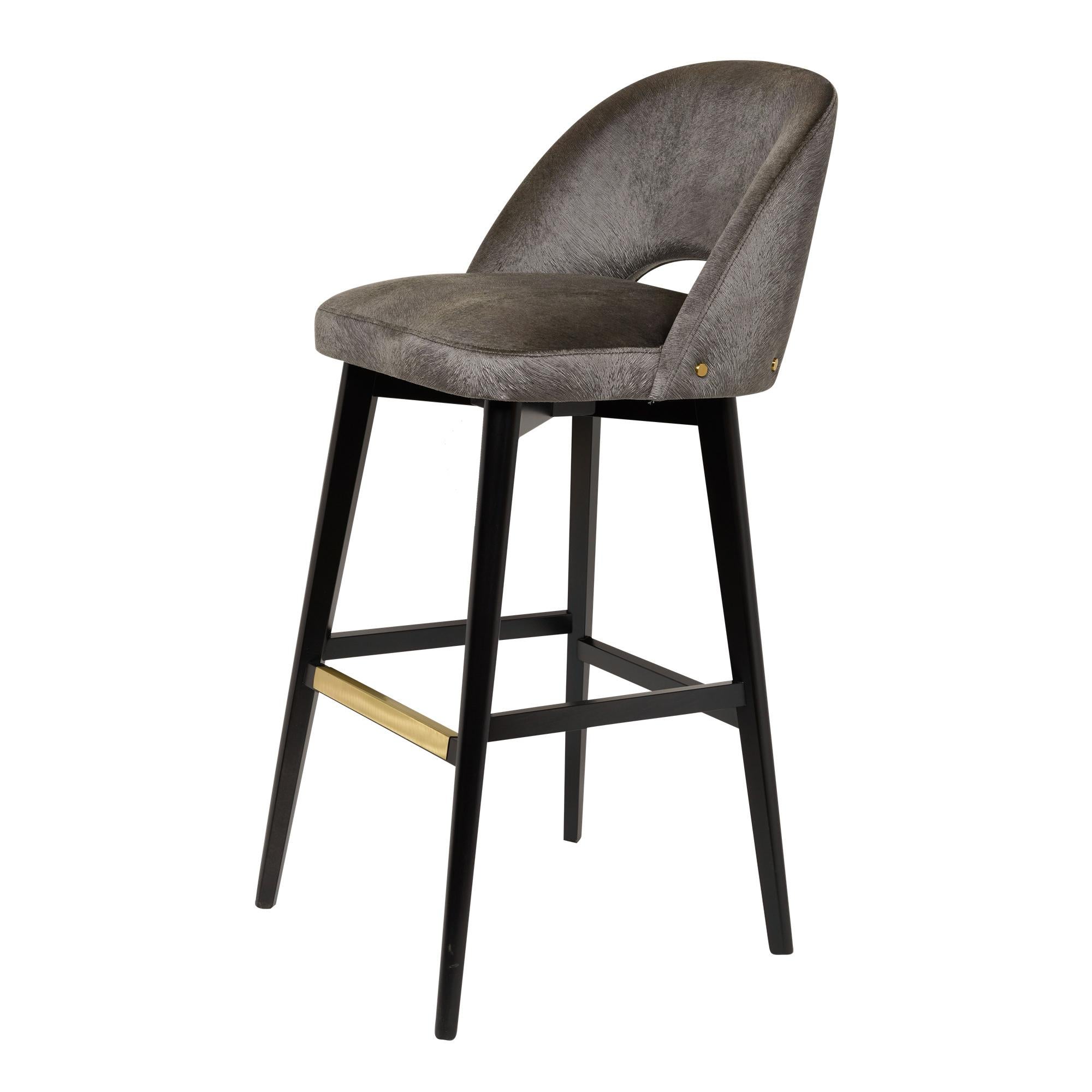 Bar stool with dark wenge stained beech legs, fully upholstered seat and back and brass footrest.
Available in counter or bar height and totally customizable including finish, wood, metal and COM.
Can be made with a swivel seat.