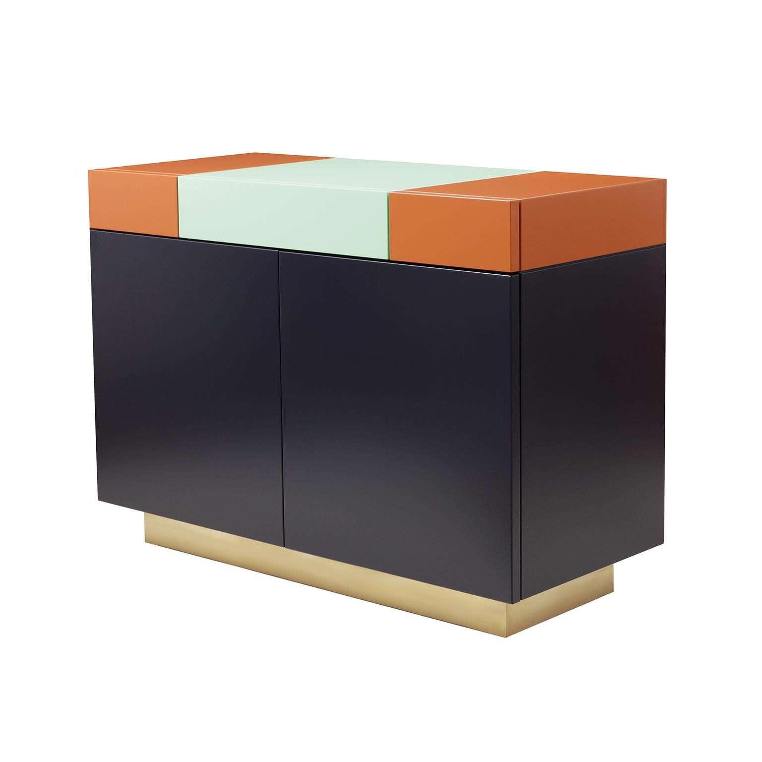 A functional and practical cabinet, based on a discrete elegance, Greta combines a playful geometrical assembling of shapes and colors.
The outside is formed by 3 drawers on top and 2 doors beneath them, all of which with the lacquer color and