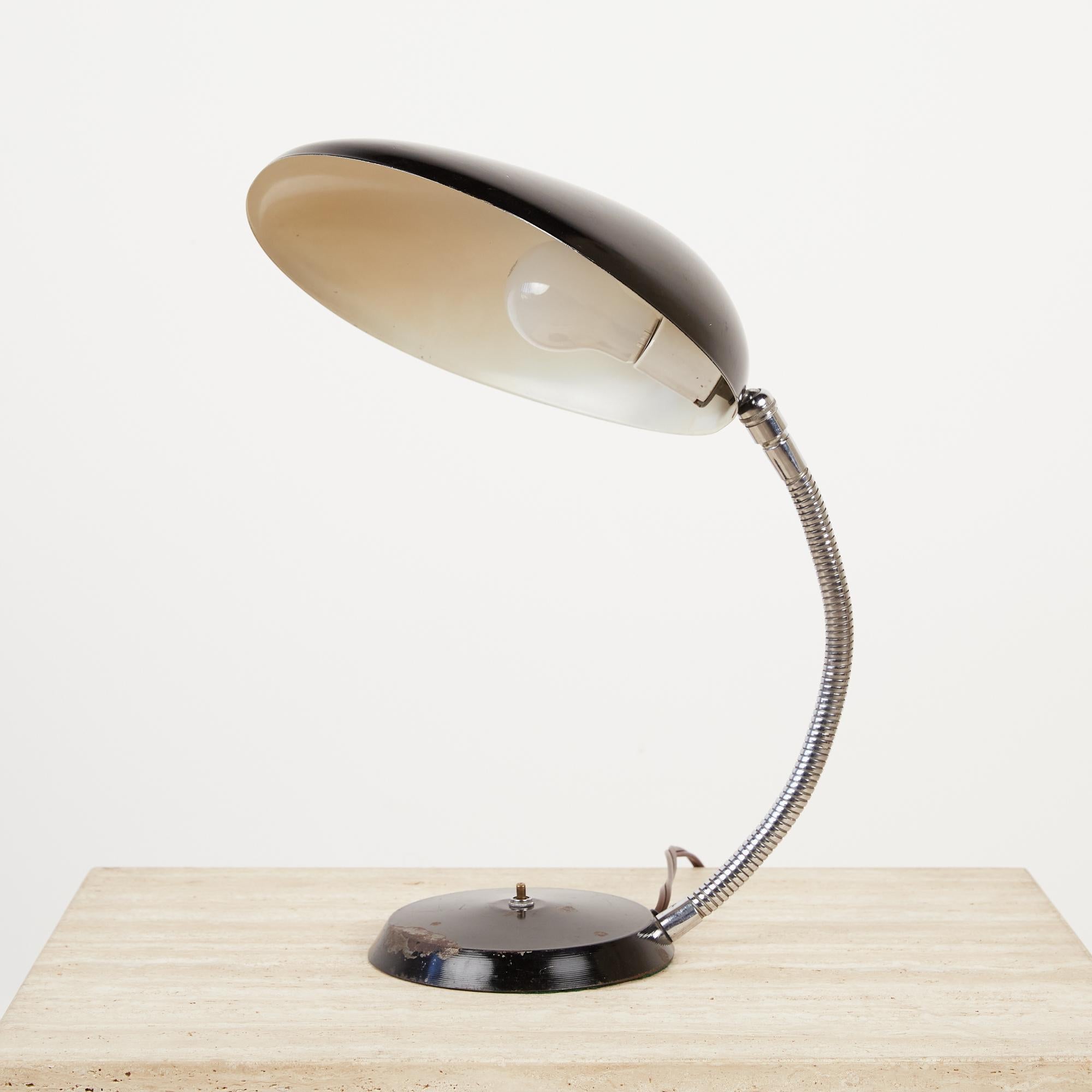 An award-winning 1948 design by Swedish-American Greta Grossman for Ralph O. Smith, a California-based lighting company. The lamp, colloquially known as the “Cobra” for its uniquely shaped shade that resembles a cobra’s hood, is counterweighted with