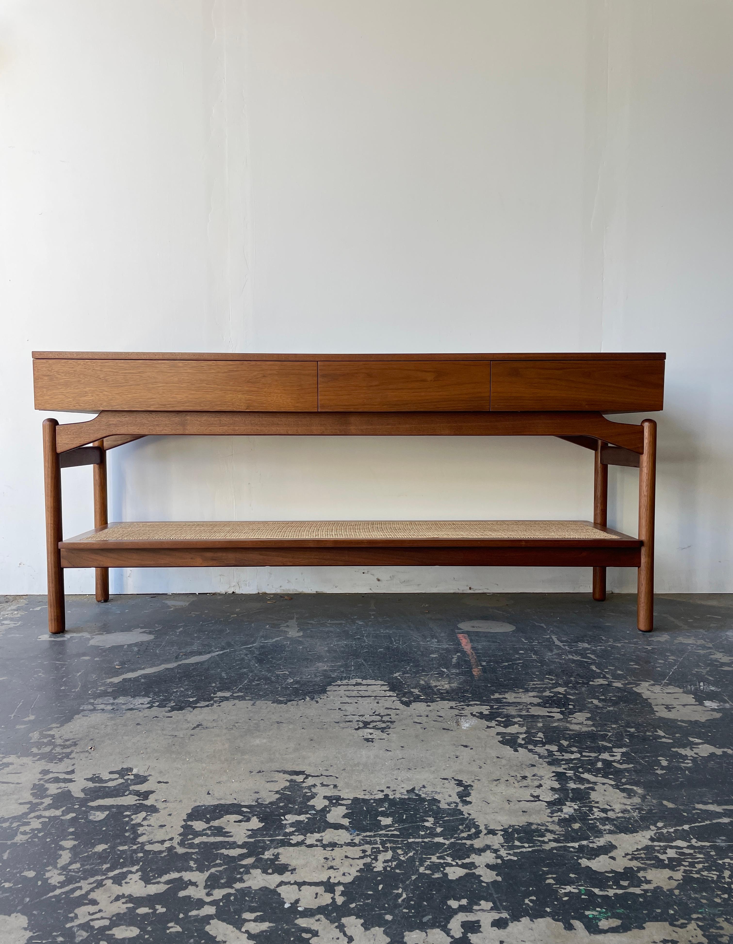 Gorgeous Greta Grossman Console table in walnut that features 3 drawers and a case that floats off the legs. This is also an amazing piece for behind a sofa. It is finished in all sides so it can float in a room. This piece could work well at an