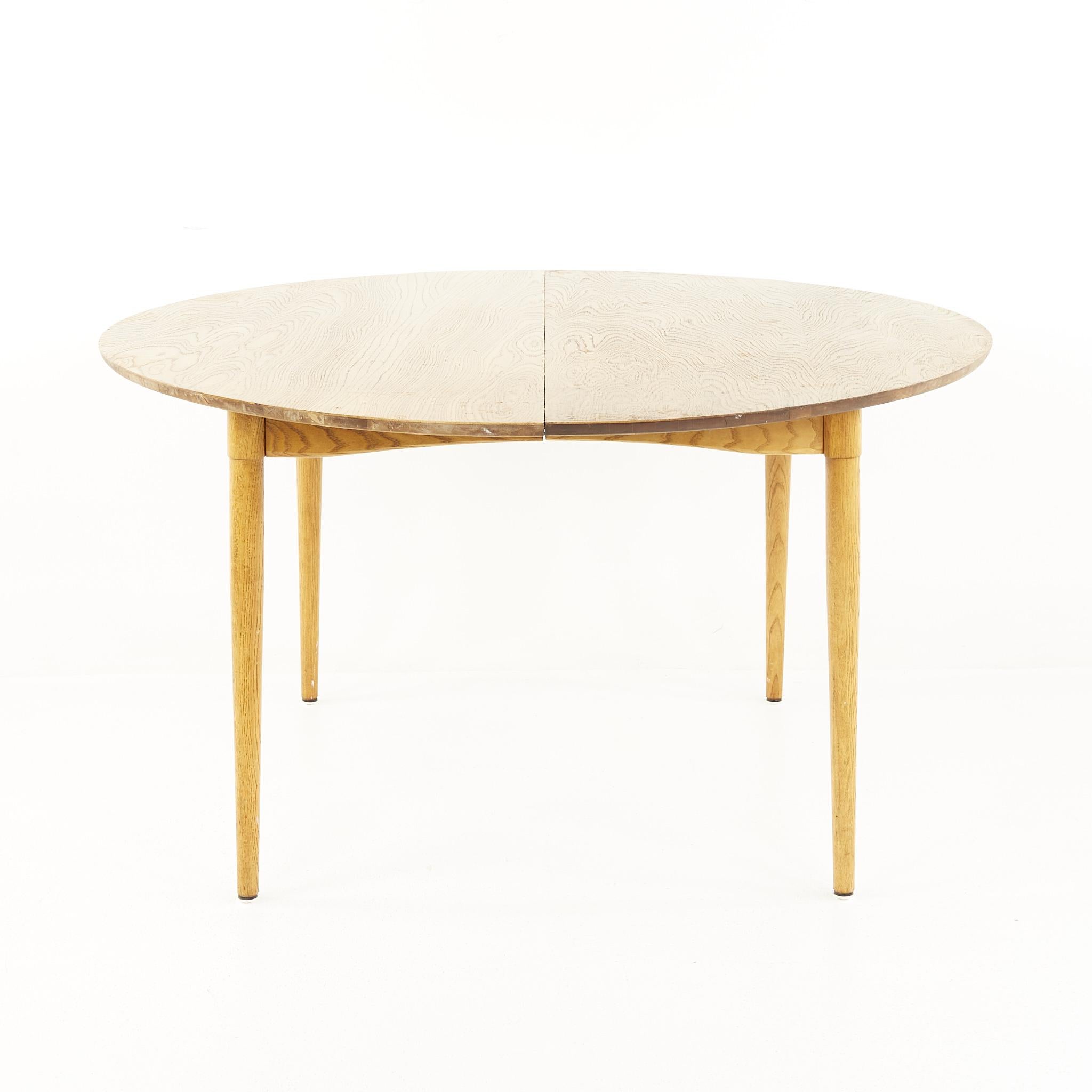 Greta Grossman For Glenn of California Mid Century dining table

The table measures: 47.5 wide x 47.5 deep x 26 high, with a chair clearance of 23 inches; the leaf measures 23.5 inches wide, making a maximum table width of 71 inches when the leaf