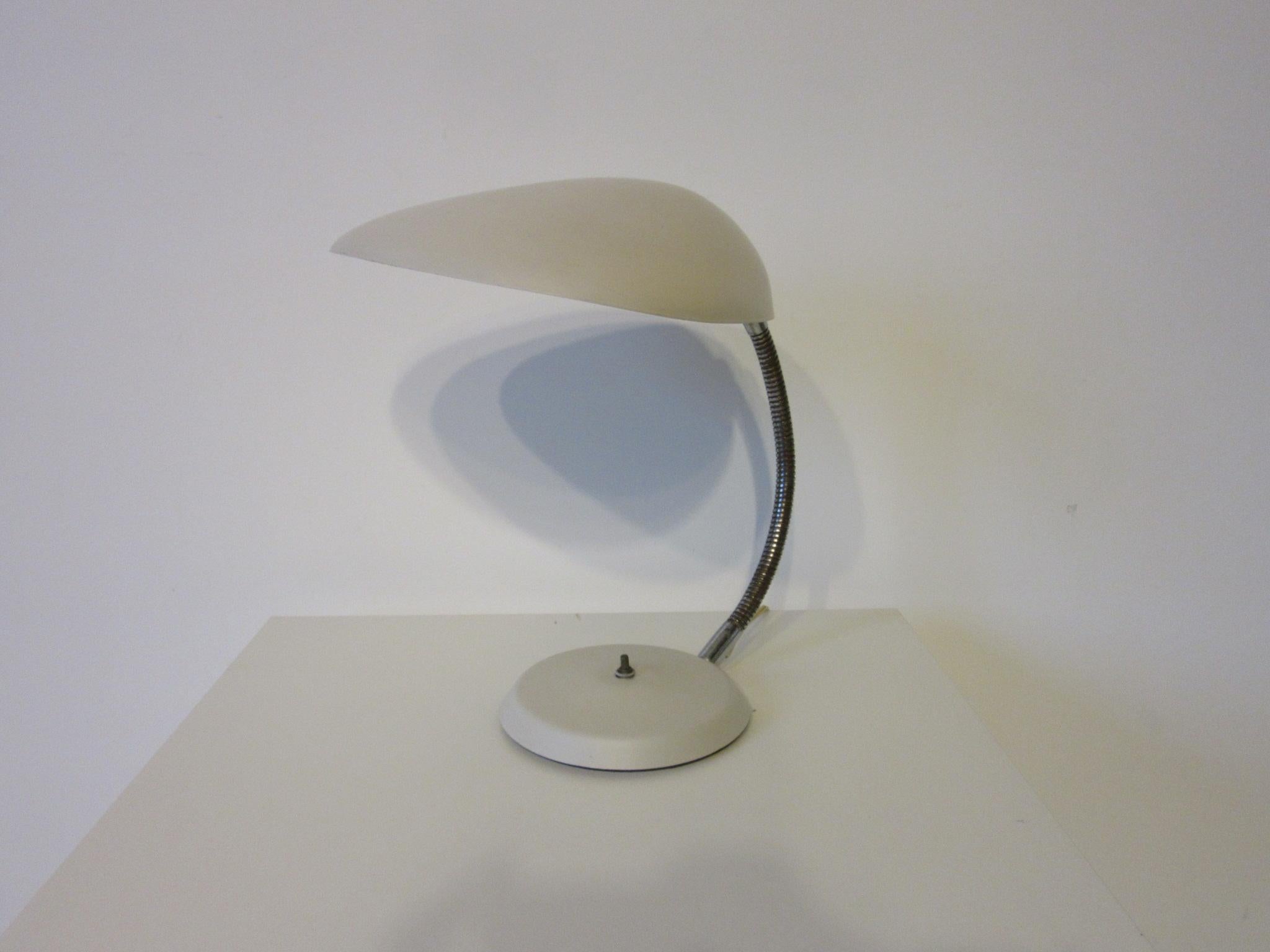 A vintage Cobra lamp with a satin off white finish to the metal shade and base , push button switch and satin chrome flexible arm . One of Greta Magnusson - Grossman's most iconic designs for The Ralph O. Smith Modern lighting company catalog model