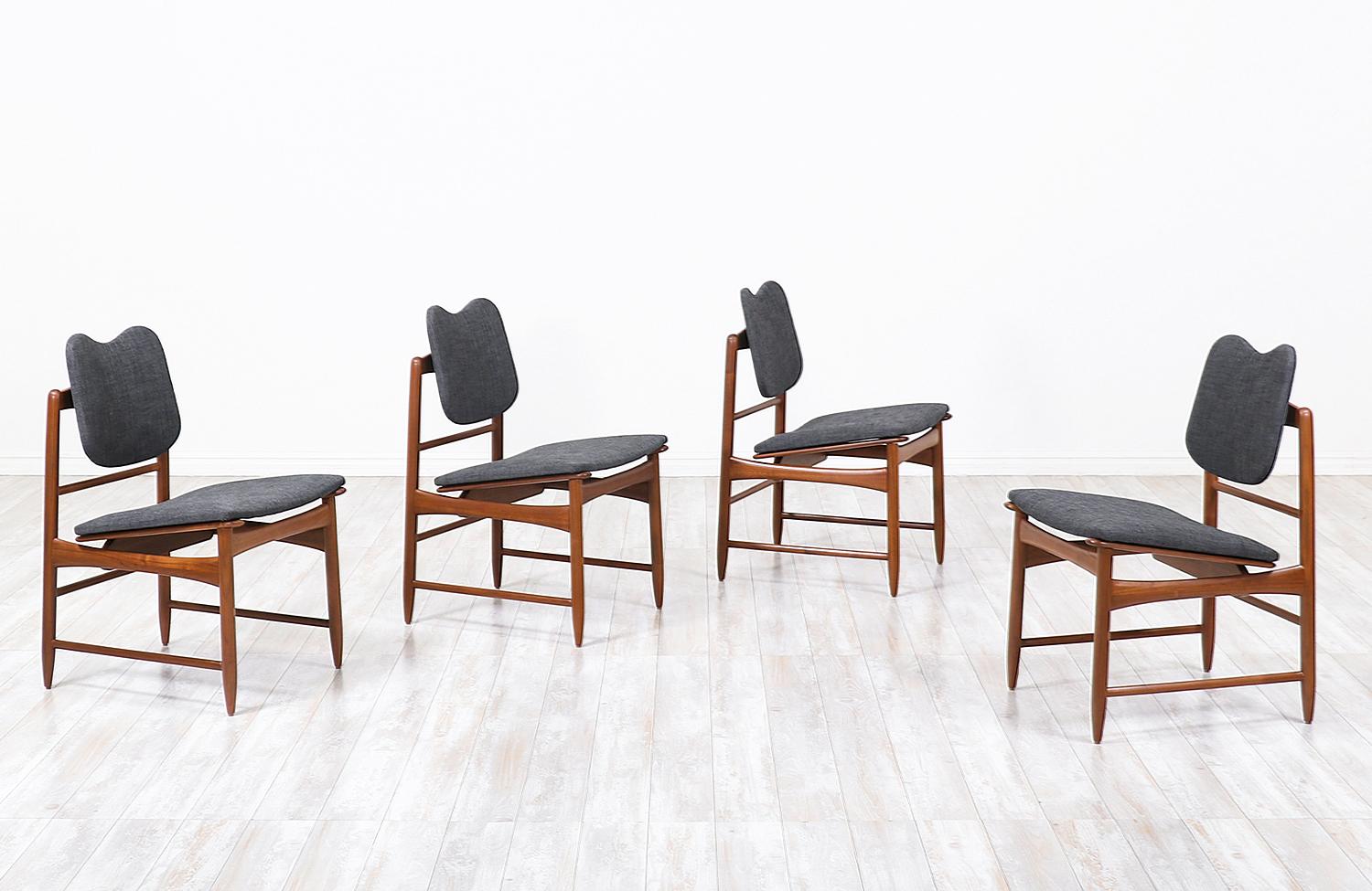 Elegant set of four dining chairs designed by Greta M. Grossman for Glenn of California in the United States, circa 1950s. This beautiful set of dining chairs feature a sturdy walnut wood frame with an angled seat and a heart-shaped top backrest.