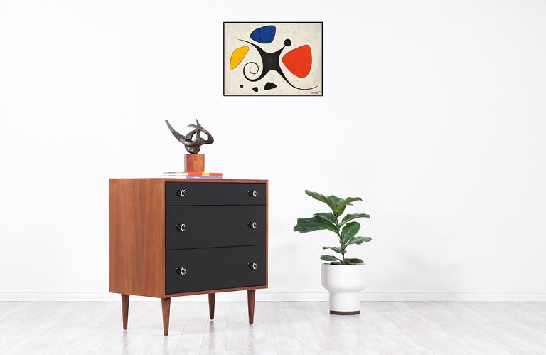 Elegant walnut chest designed by Swedish architect and designer Greta M. Grossman for Glenn of California in the United States circa 1950s. This compact chest is made with a walnut wood case and accented on the front with a black high-polished