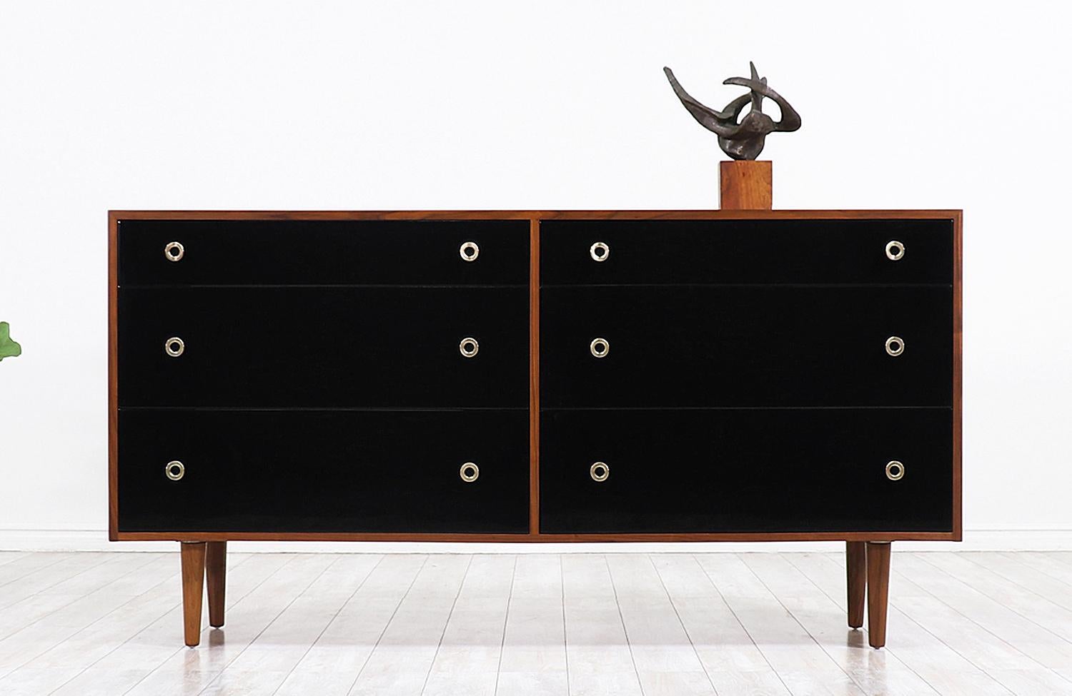 Elegant lacquered dresser designed by Swedish architect Greta M. Grossman for Glenn of California in the United States circa 1950s. This original and iconic modern design is comprised of a walnut wood case that sits on four tapered legs featuring
