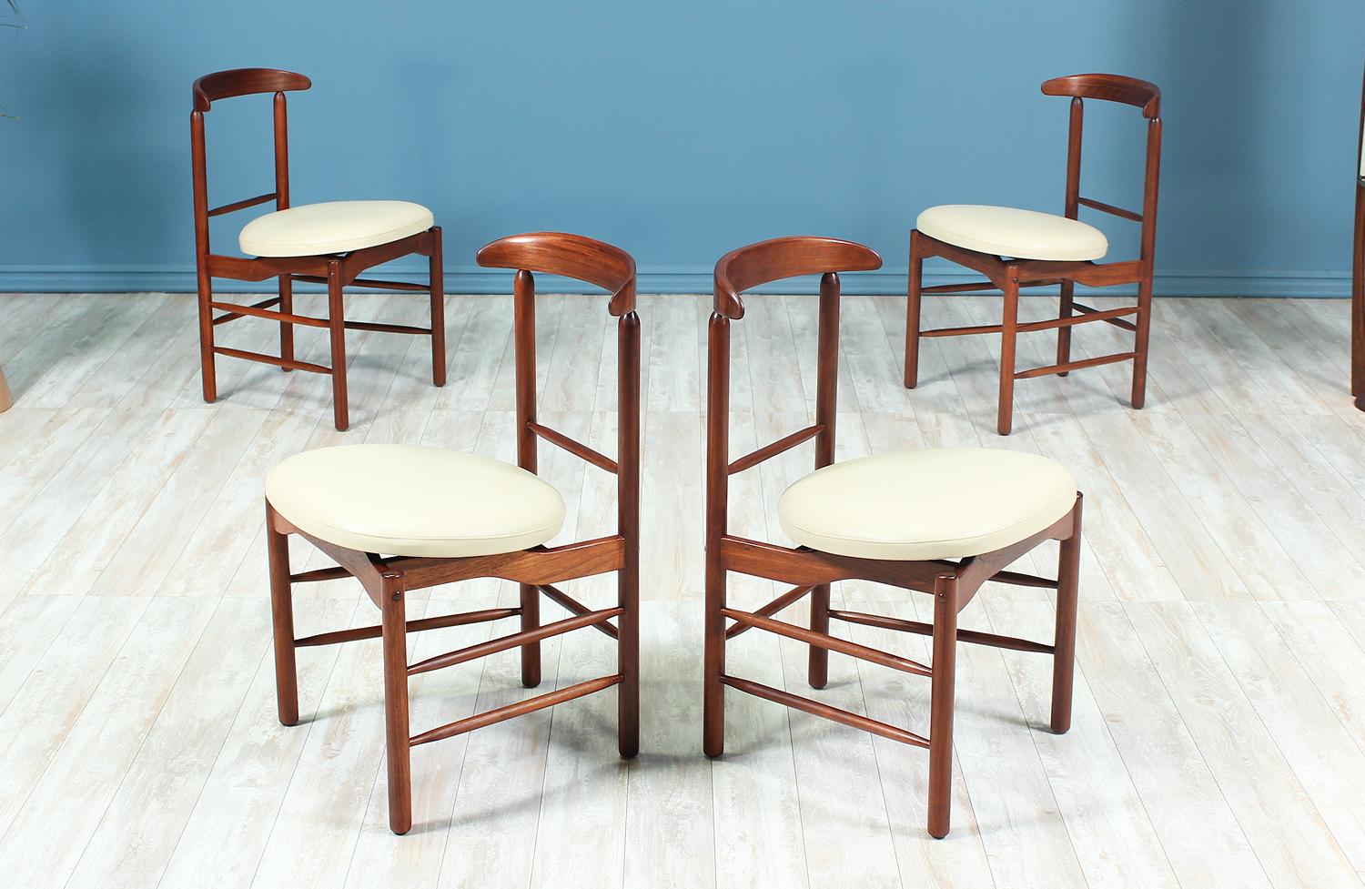 Set of four dining chairs designed by Greta M. Grossman for Glenn of California in the United States circa 1950s. All four chairs have been newly upholstered in a high-quality and comfortable white grain leather and feature a solid walnut wood frame