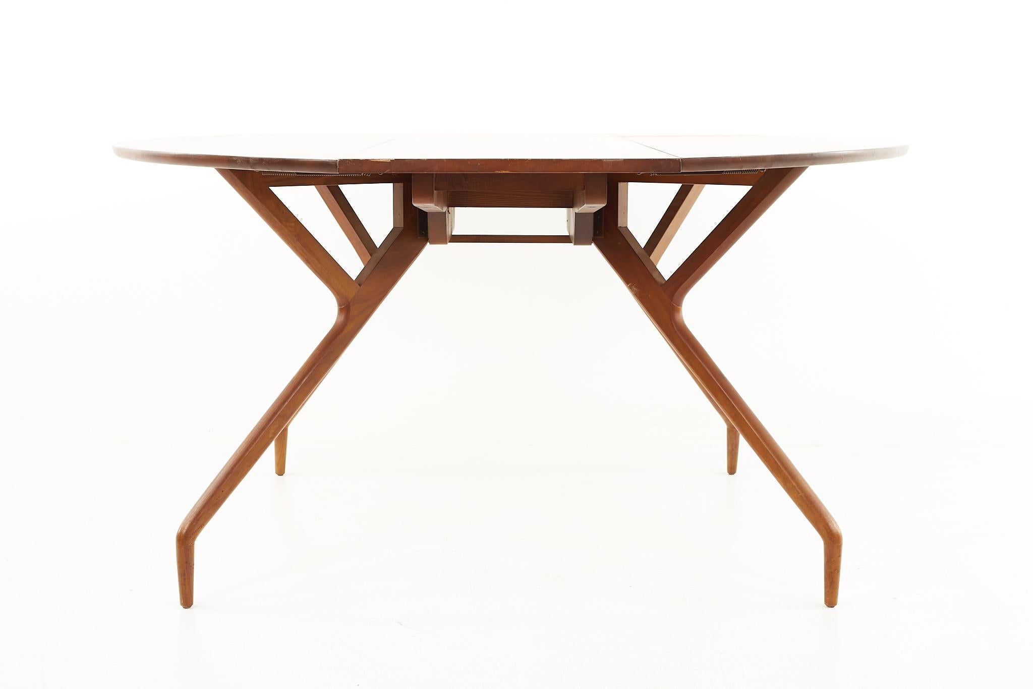 Greta Magnusson Grossman and Edward Frank mid century spider drop leaf dining table

The table measures:18 wide x 60 deep x 28.5 high, with a chair clearance of 27.5 inches high; when the table is opened it measures 54 inches wide 

All pieces