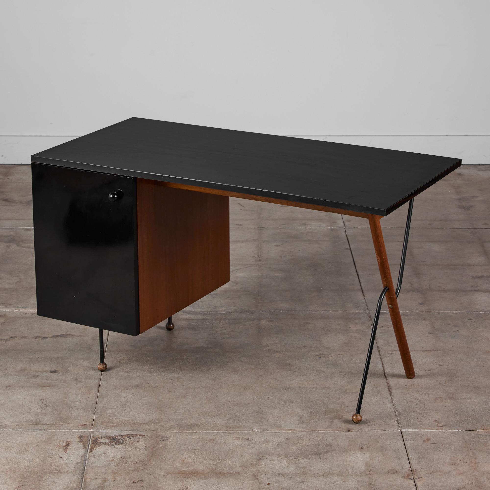 Greta Magnusson-Grossman desk for Glenn of California, c.1950s, USA. This stunning desk features a mixed base of walnut and iron with a black laminated writing surface and cabinet door front. The legs consist of solid black iron and spherical wood