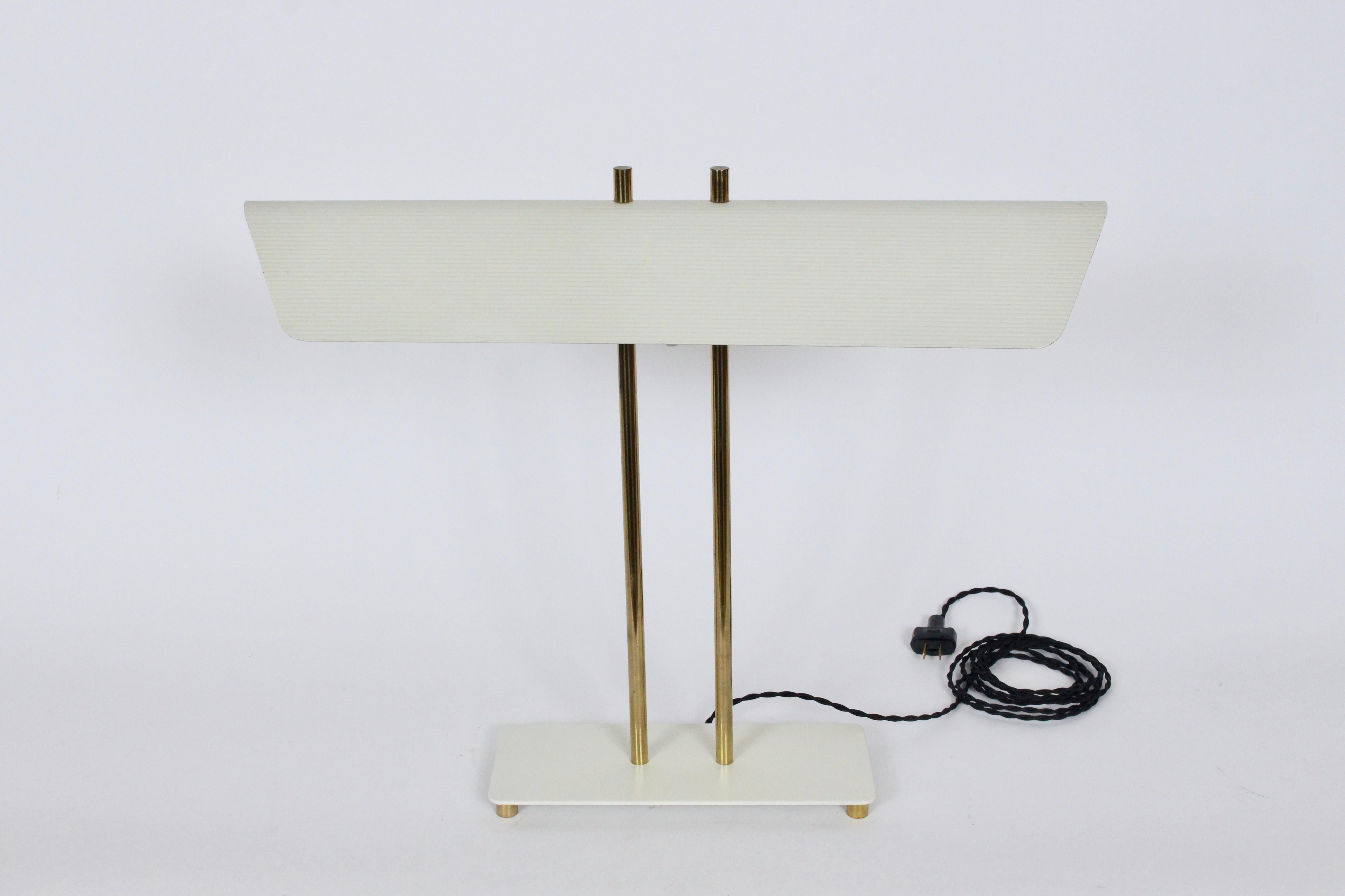 Nessen Studios Greta Von Nessen attributed off white and brass desk lamp. Featuring a fluted off white enameled triangular shade detailed with perforated sides, two tubular brass columns, on a rectangular off white enameled (4.5 x 11) base atop four