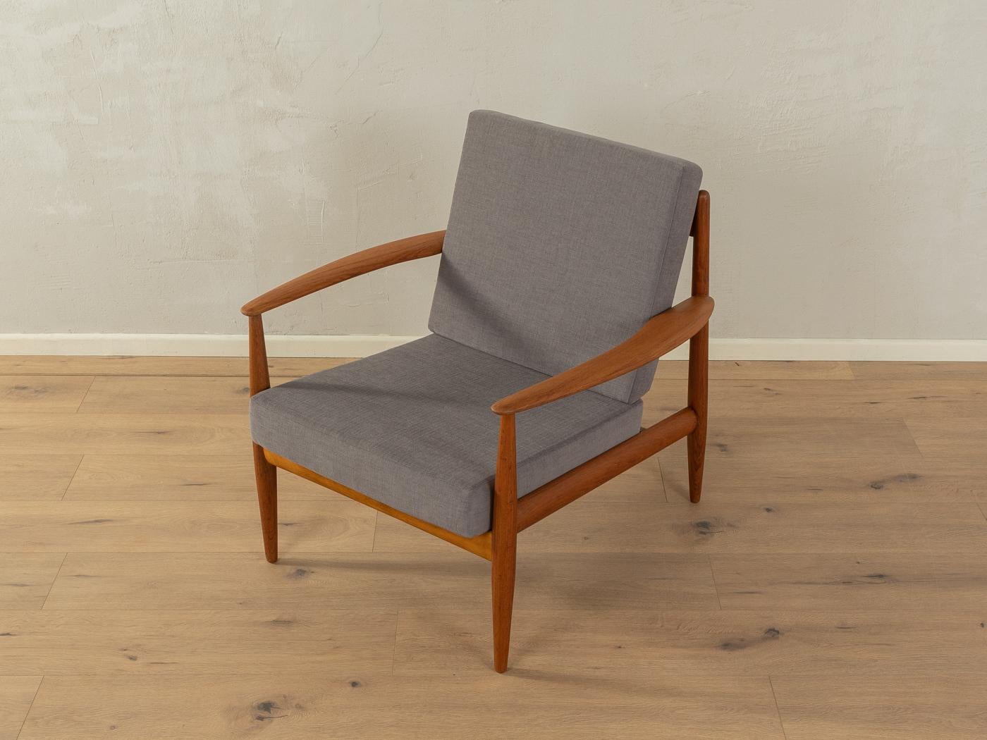Rare armchair by Grete Jalk, model 118 for France & Daverkosen. The armchair comes from the first series from 1955. High quality solid teak wood frame. The seat and backrest have been newly upholstered and covered with a high-quality gray upholstery