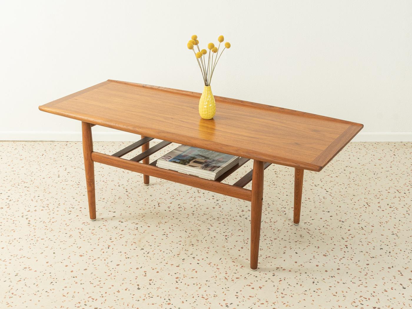 Classic 1960s coffee table by Grete Jalk for Glostrup. Solid frame in teak and a table top in teak veneer with solid wood edge. Made in Denmark.

Quality Features:
- Accomplished design: perfect proportions and visible attention to detail
-