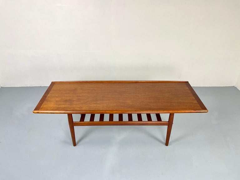 Iconic Scandinavian coffee table in beautiful teak.
The large coffee table has a shelf for magazines and fits perfectly with larger sofas. 


The candleholders and the vase are not included.