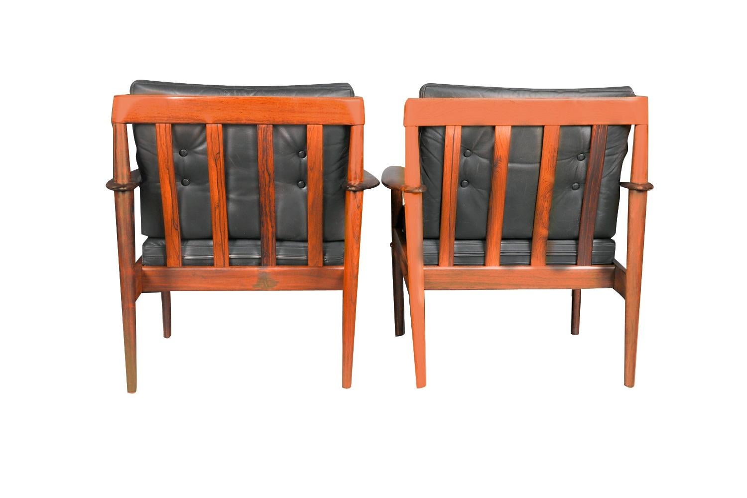 A stunning, rare pair of Mid-Century Modern Grete Jalk lounge chairs, Mod. PJ (Poul Jeppesen) (Model 56) 1960's rosewood, lounge arm chairs designed by Grete Jalk for Poul Jeppesen made in Denmark. An exceptional pair, both for their form and